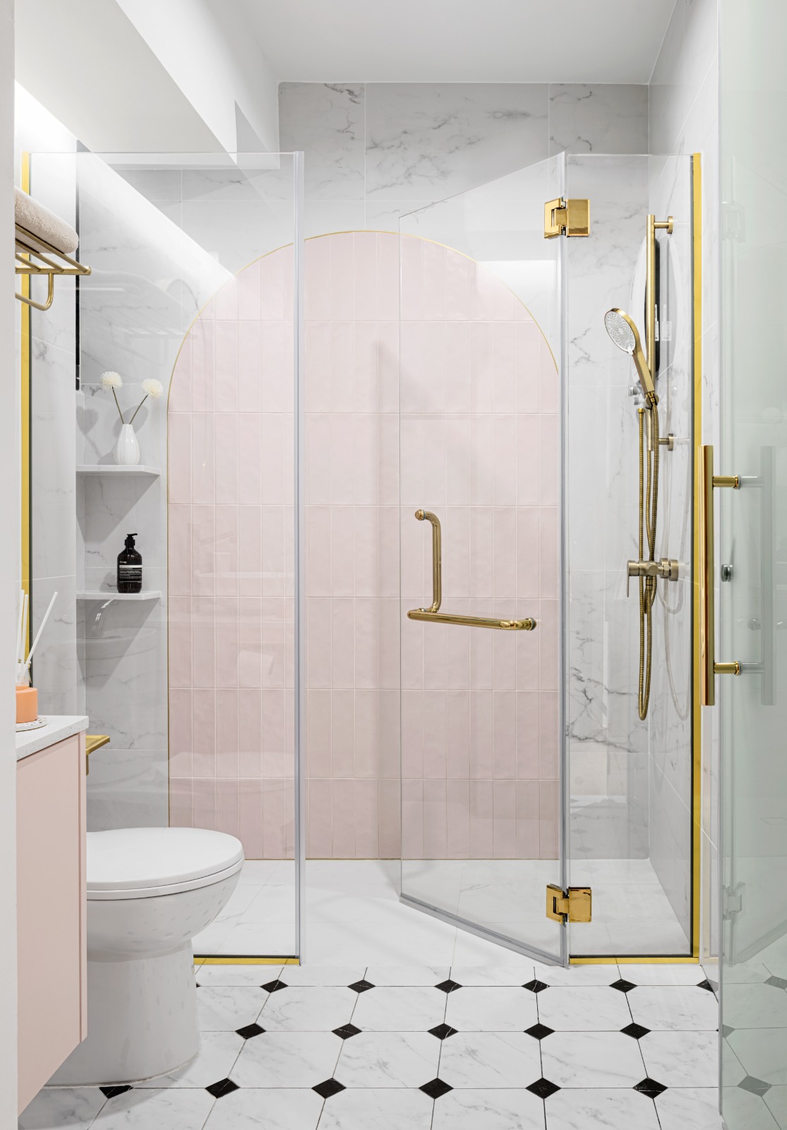 A peek into a 4 Room BTO at Northeast - Modern bathroom with glass shower enclosure, pink-tiled shower wall, gold fixtures