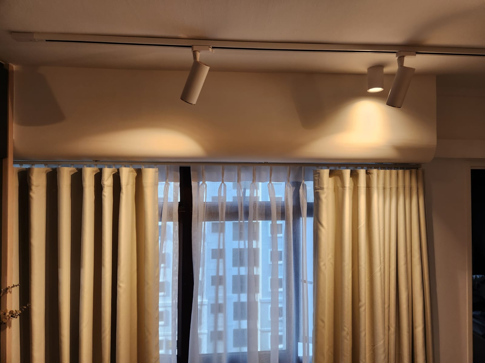 Aircon Trunking Box Up  - Cream-colored curtains, sheer white curtains, light beige walls, modern ceiling lights, soft