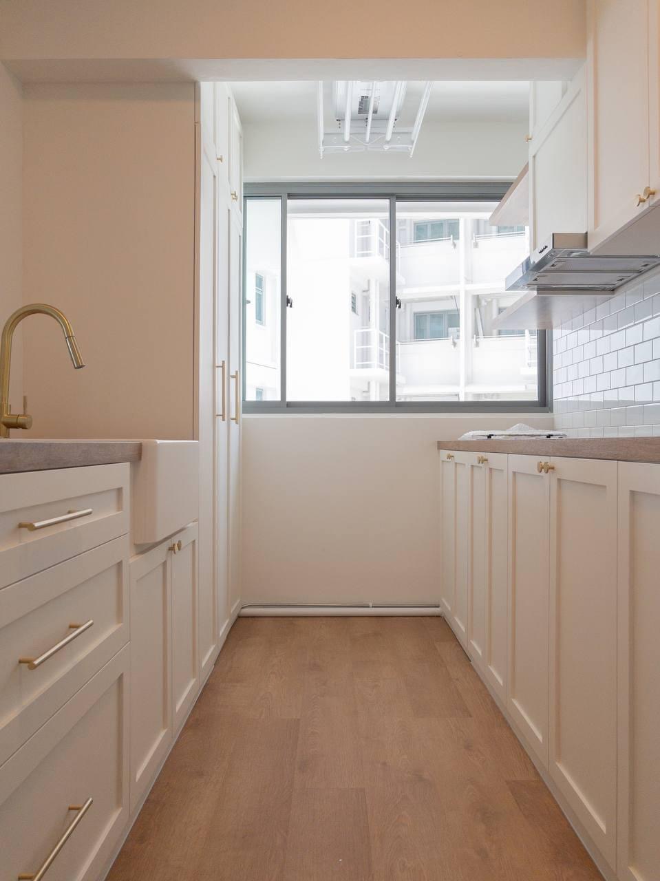 Step into our smol house with a farmhouse kitchen theme - White kitchen cabinetry, gold faucet, wooden floor, large window