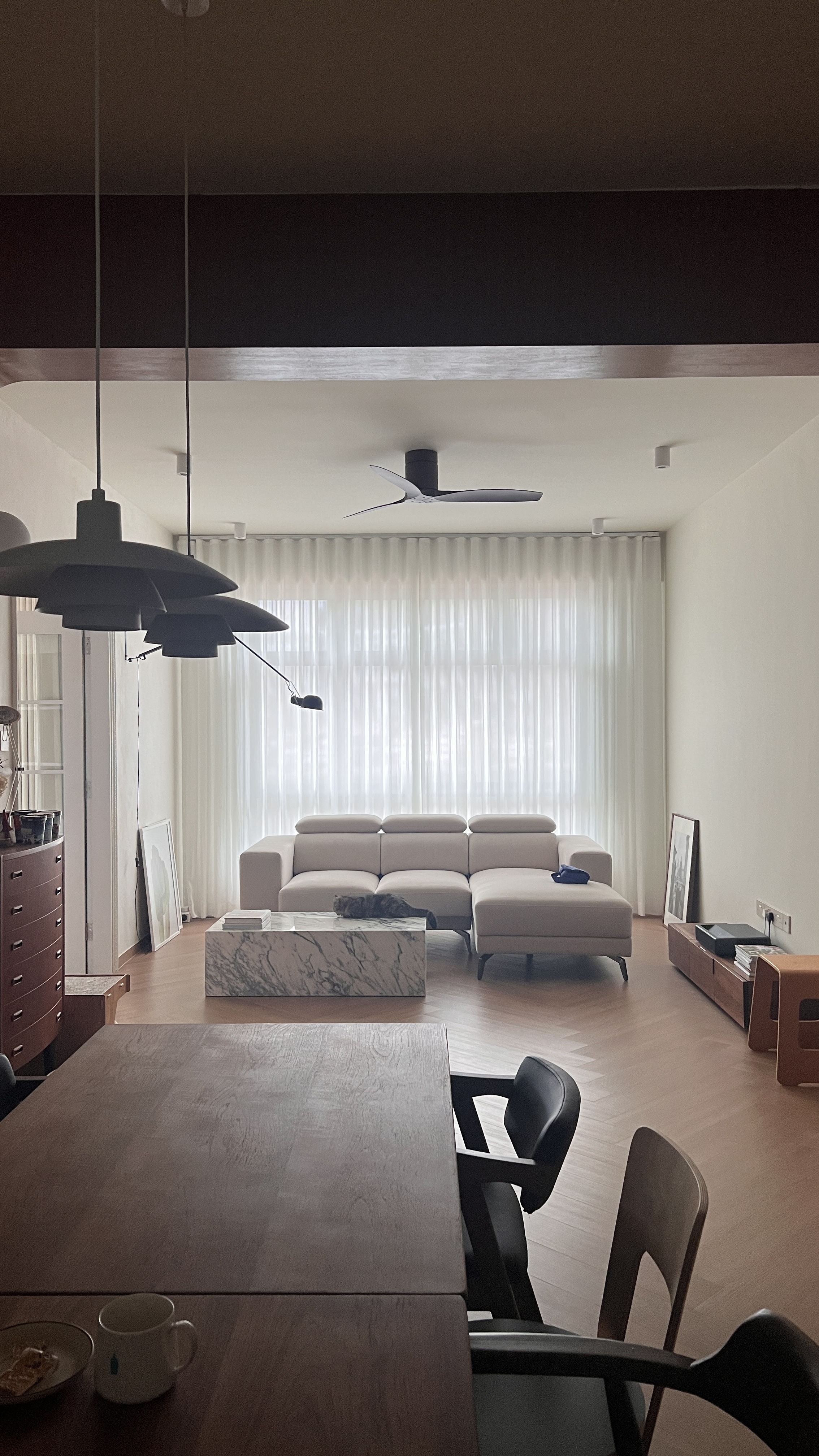 An Unconventional Design & Layout Home.  - Modern minimalist living room, neutral color palette, large window with sheer