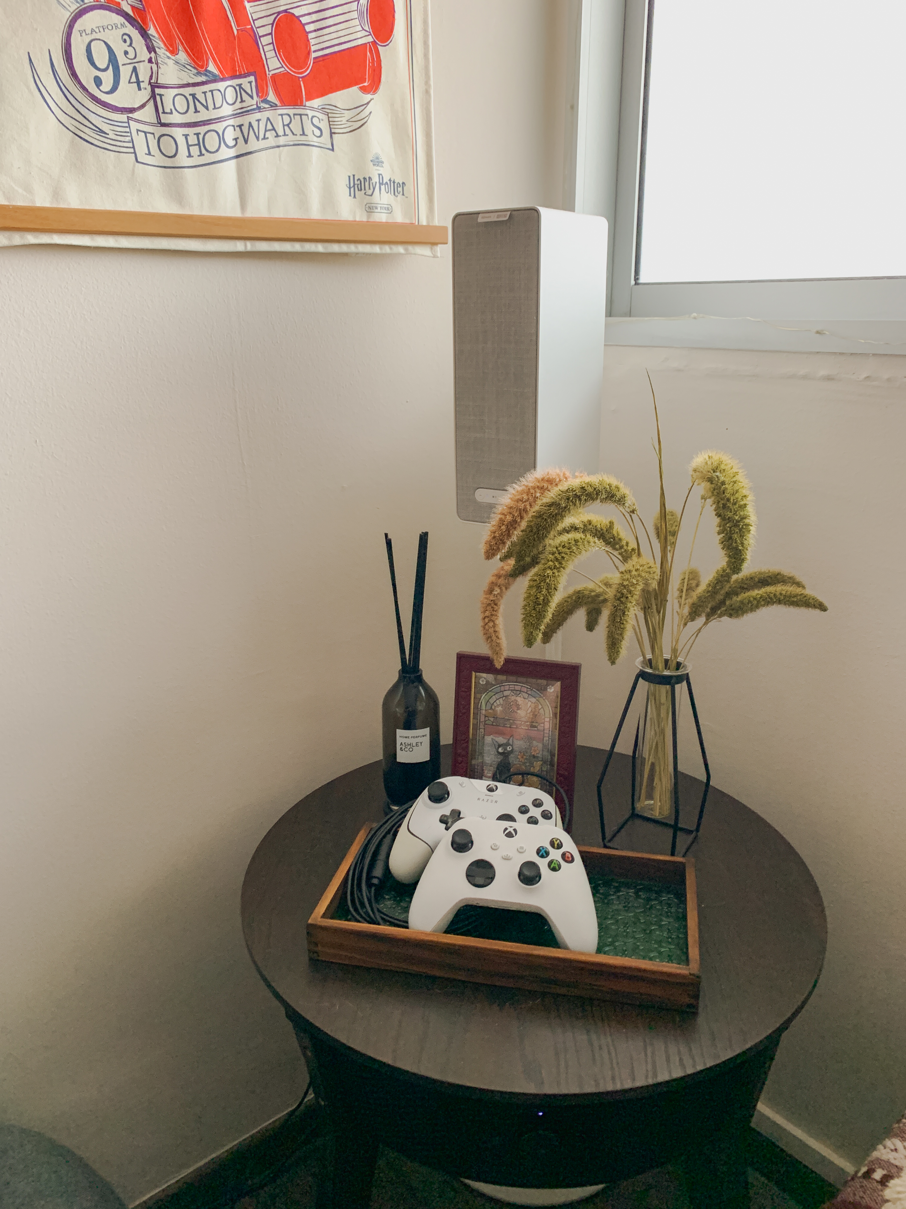 Styling a Cosy Corner for an Autumnal Mood - vintage wall art, Harry Potter poster, fluffy plant, black vase, gaming console