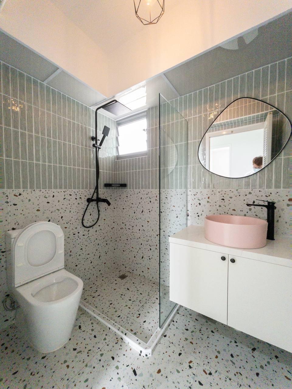 Step into our smol house with a farmhouse kitchen theme - Modern bathroom with speckled floor tiles, white toilet, glass