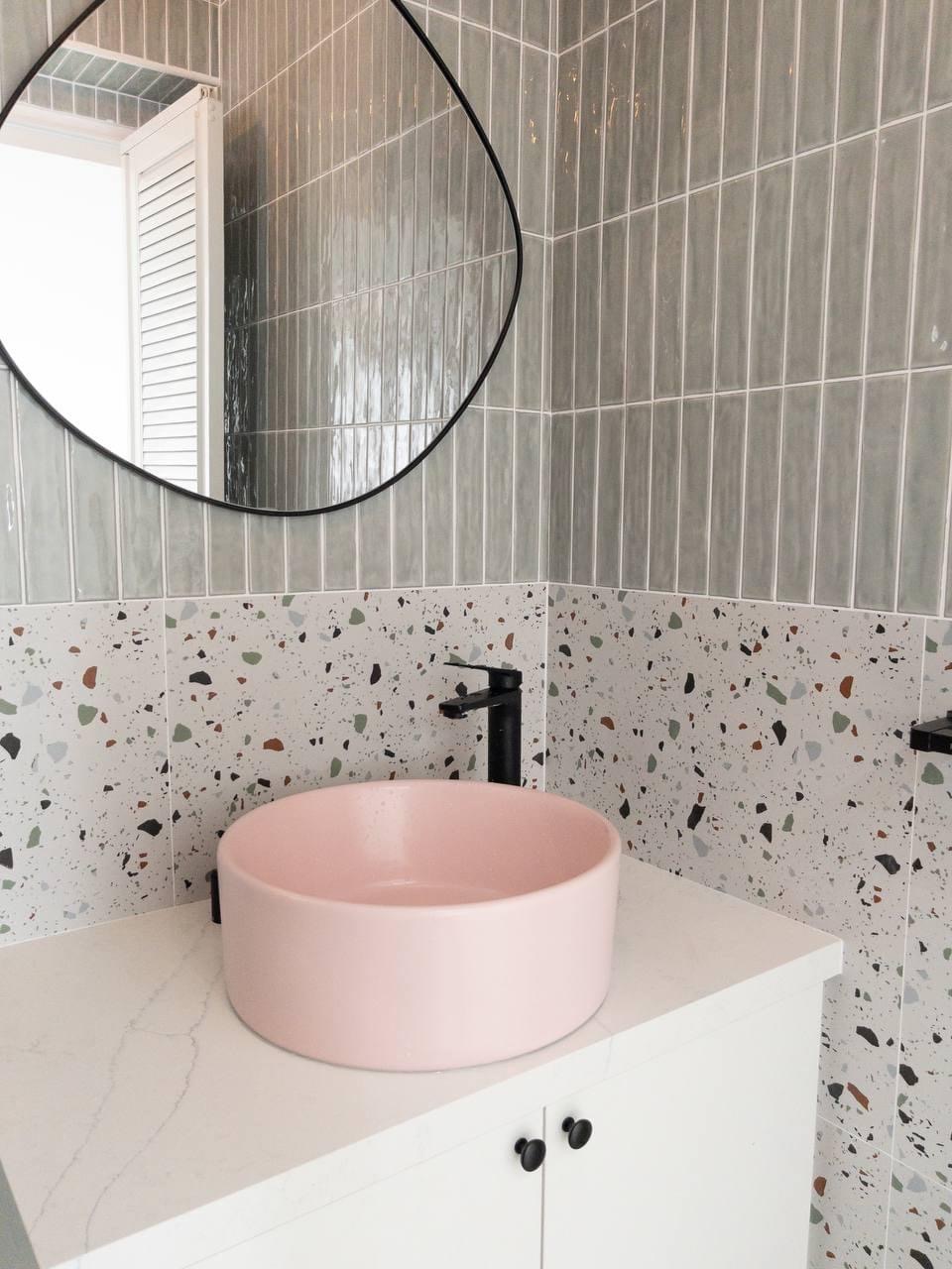 Step into our smol house with a farmhouse kitchen theme - Modern bathroom vanity, pink oval sink, white countertop, black