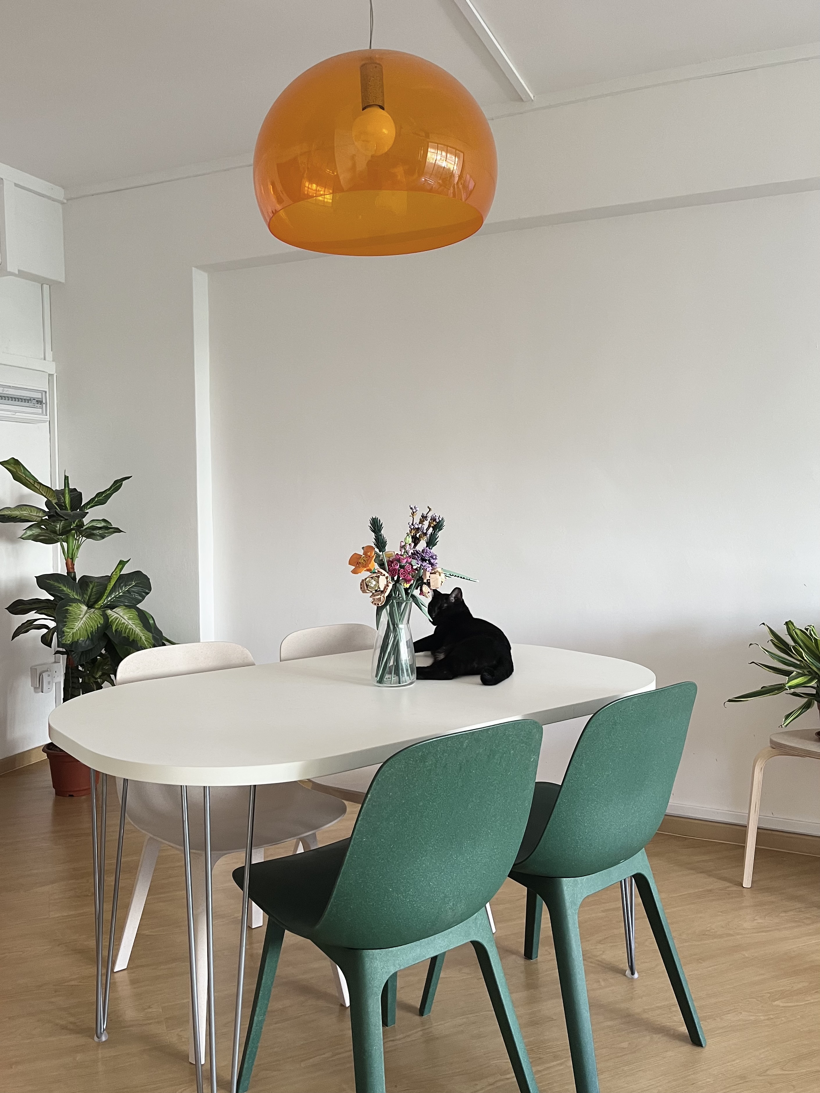 Home Sweet Kindercore - Where Fun Meets Comfort - Modern dining room, minimalist design, white round table, green chairs