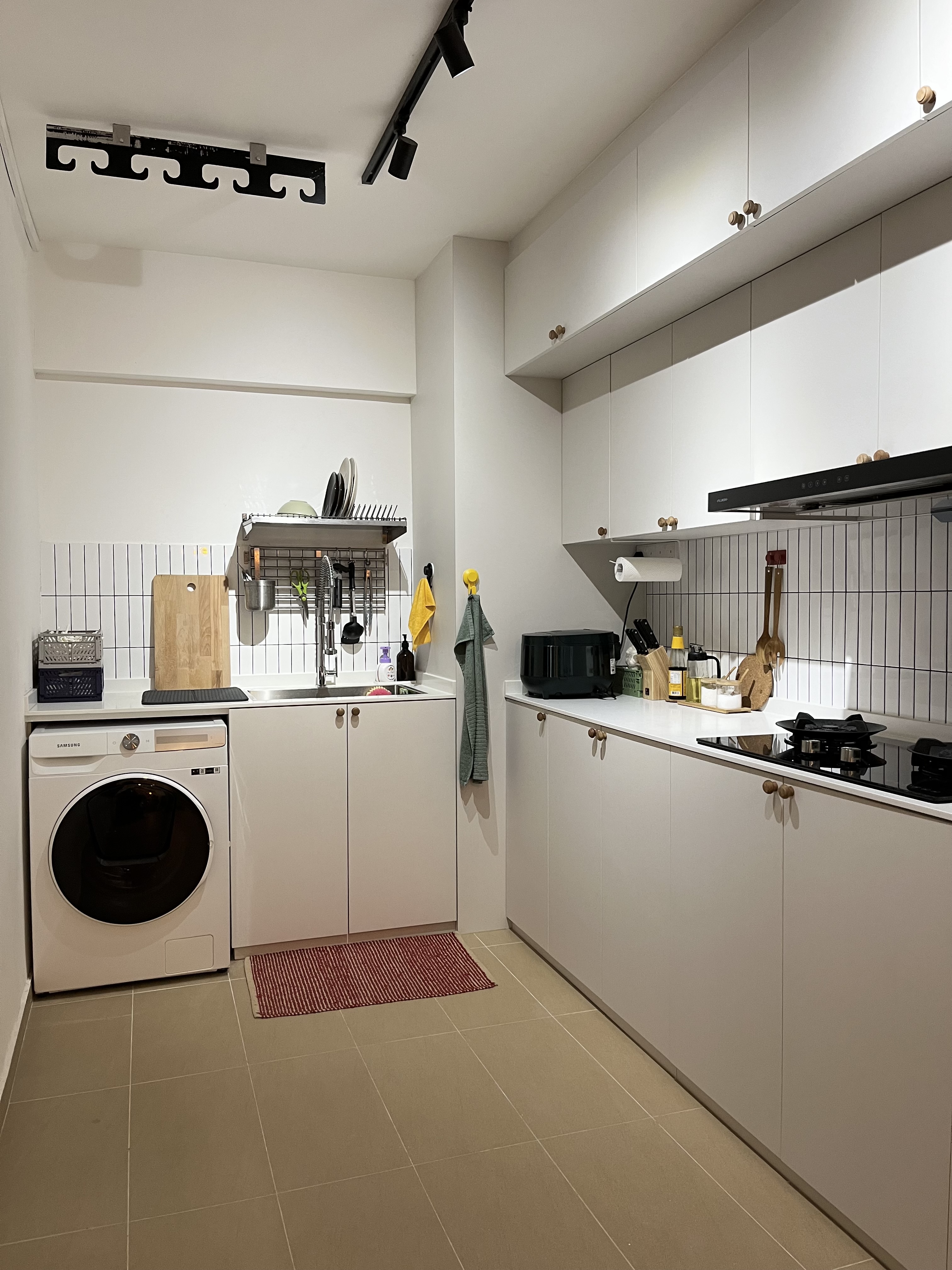 Home Sweet Kindercore - Where Fun Meets Comfort - White modern kitchen with built-in appliances, stainless steel sink, white