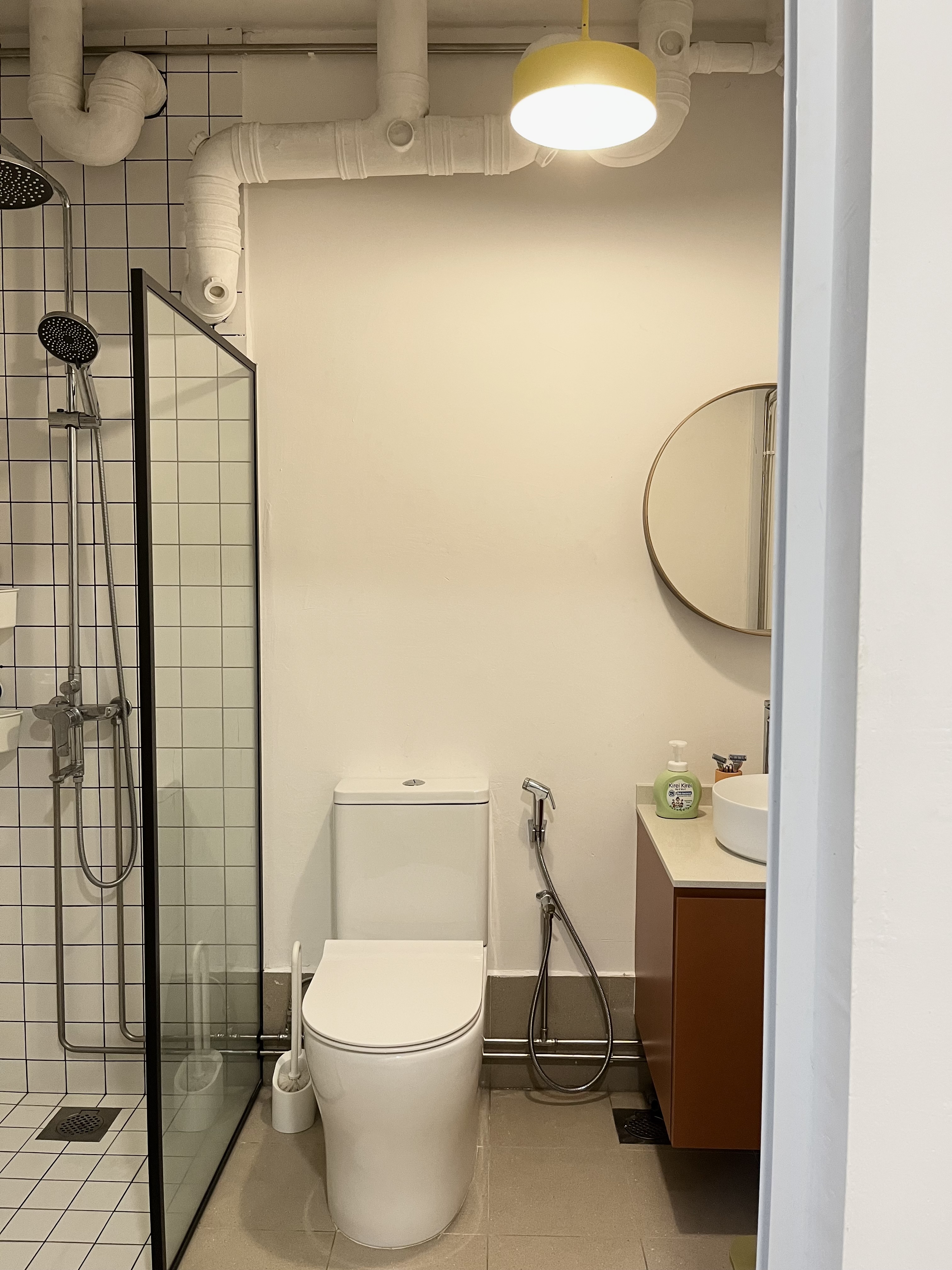 Home Sweet Kindercore - Where Fun Meets Comfort - Modern bathroom with sleek design, white tiled walls and floor, glass