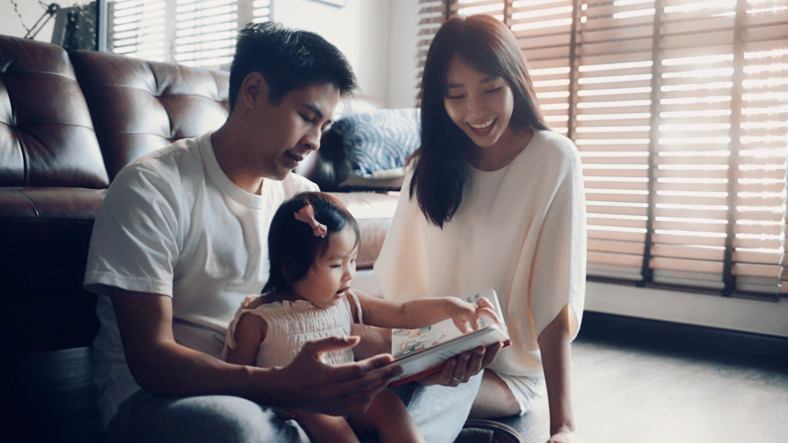 Reimagined boundaries & enlarged common spaces for us - Family, parents, child, reading, book, window, blinds, sunlight