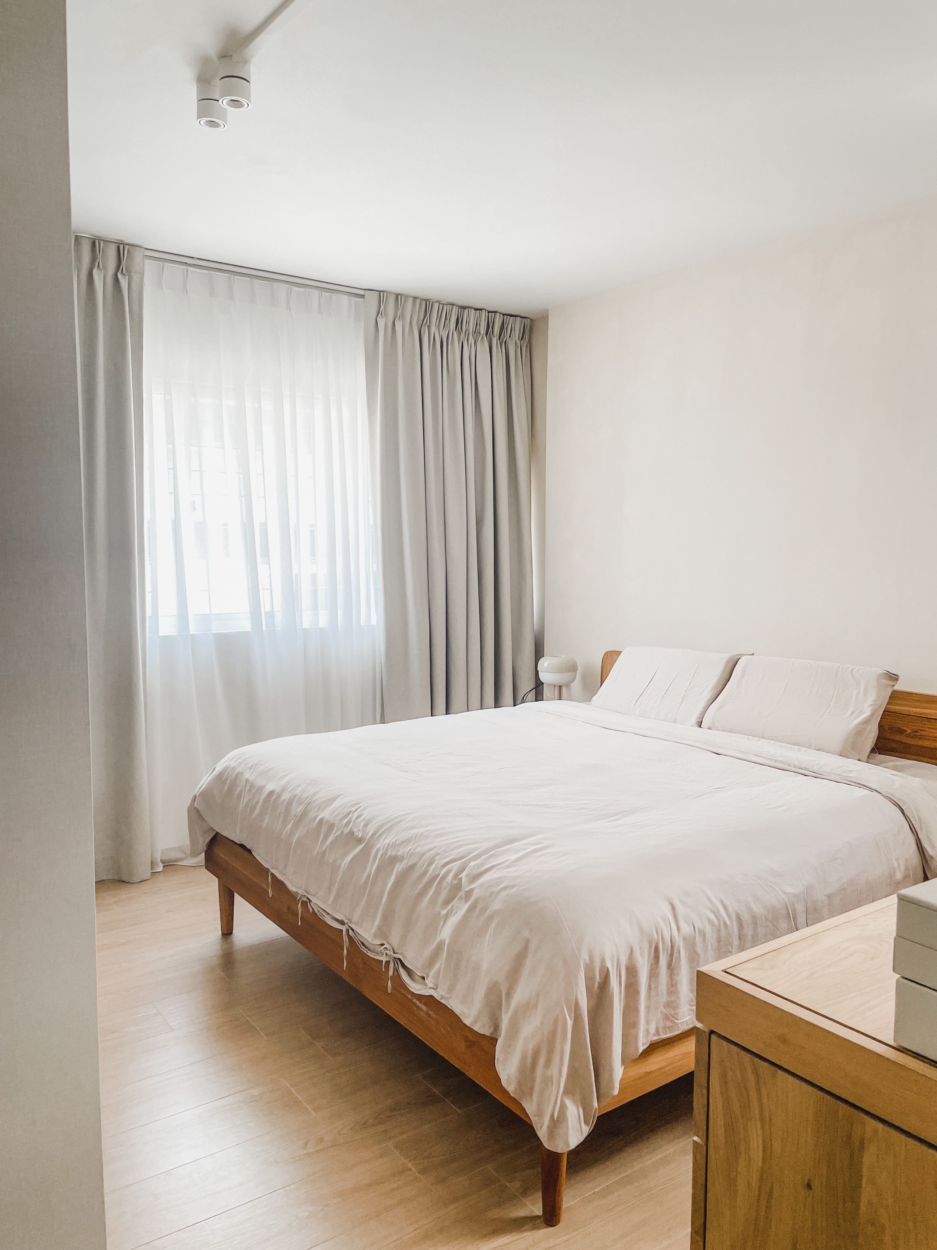 Light-filled, Open-plan Scandi Executive Apartment - Light-colored, minimalist bedroom with large bed, wooden headboard