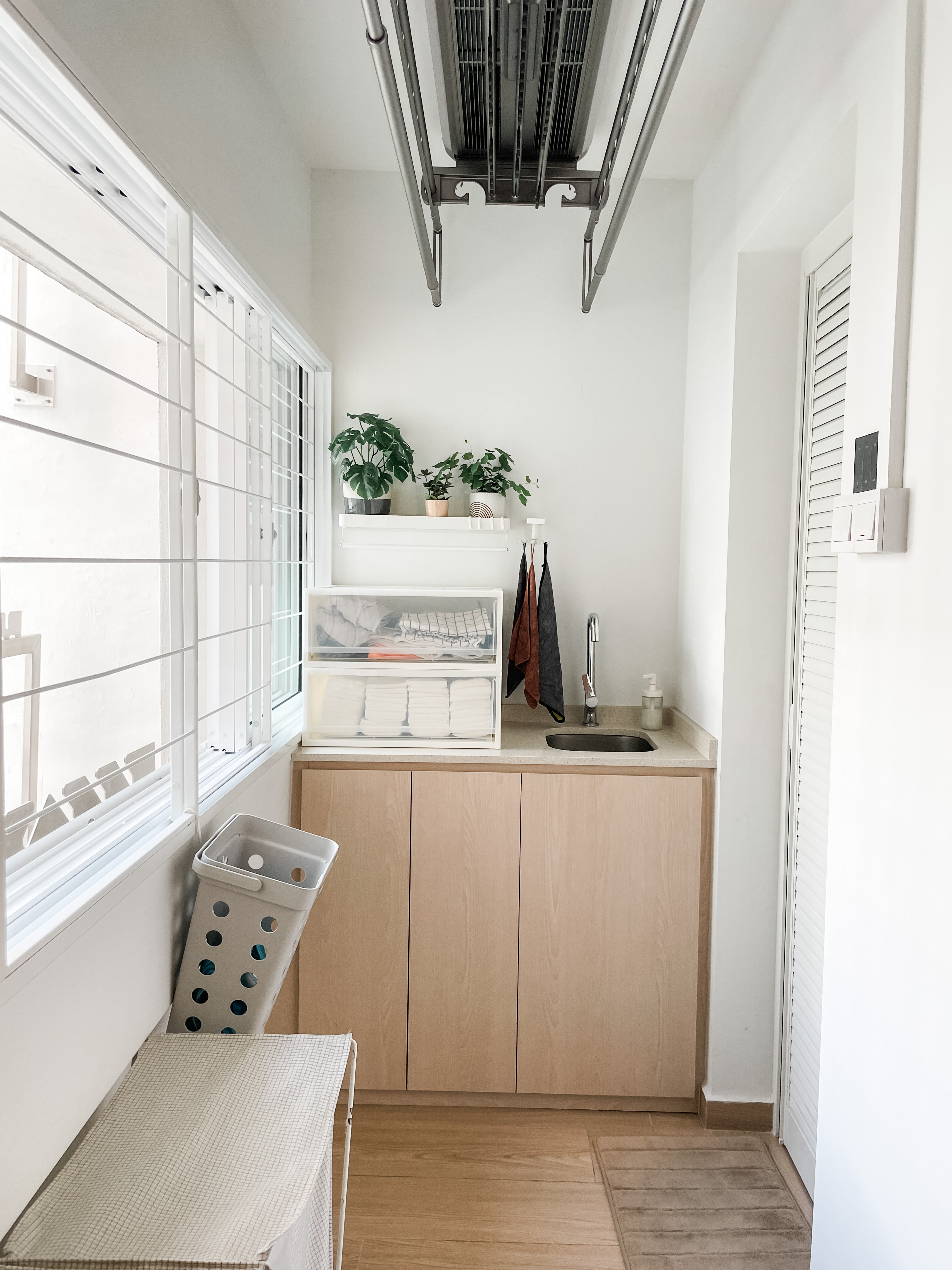 Light-filled, Open-plan Scandi Executive Apartment - White kitchen with wooden cabinets, light brown countertop, built-in
