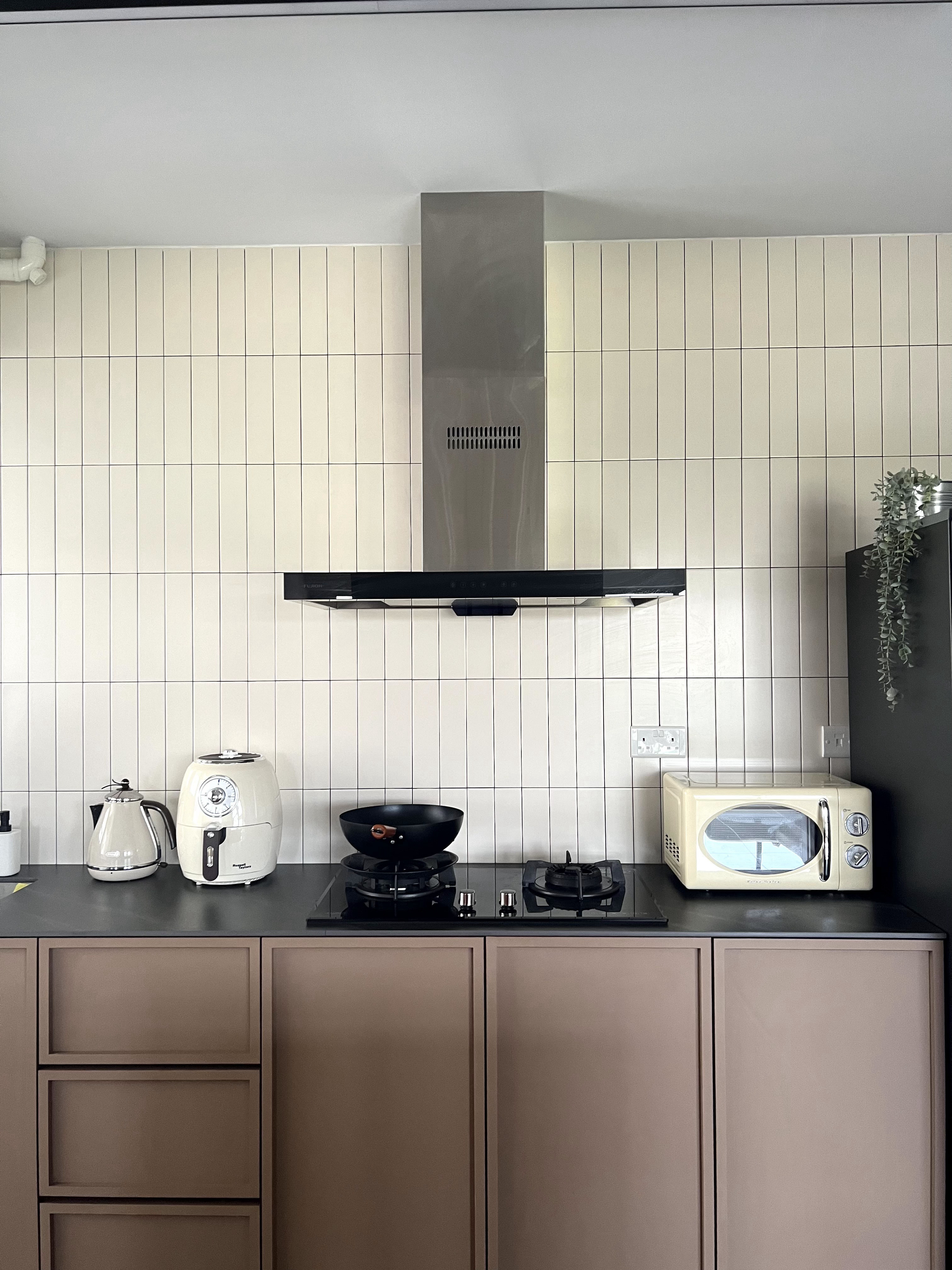 From Blank Canvas to Cosy Haven - White tiled kitchen backsplash, modern appliances, black range hood, white kettle, white