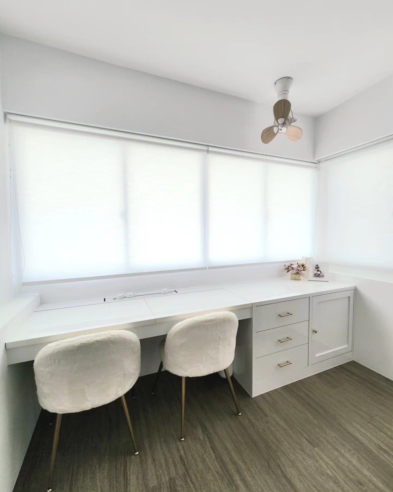Living in our dream Wang Gong  - White minimalist workspace, modern desk, two cushioned chairs, natural light streaming