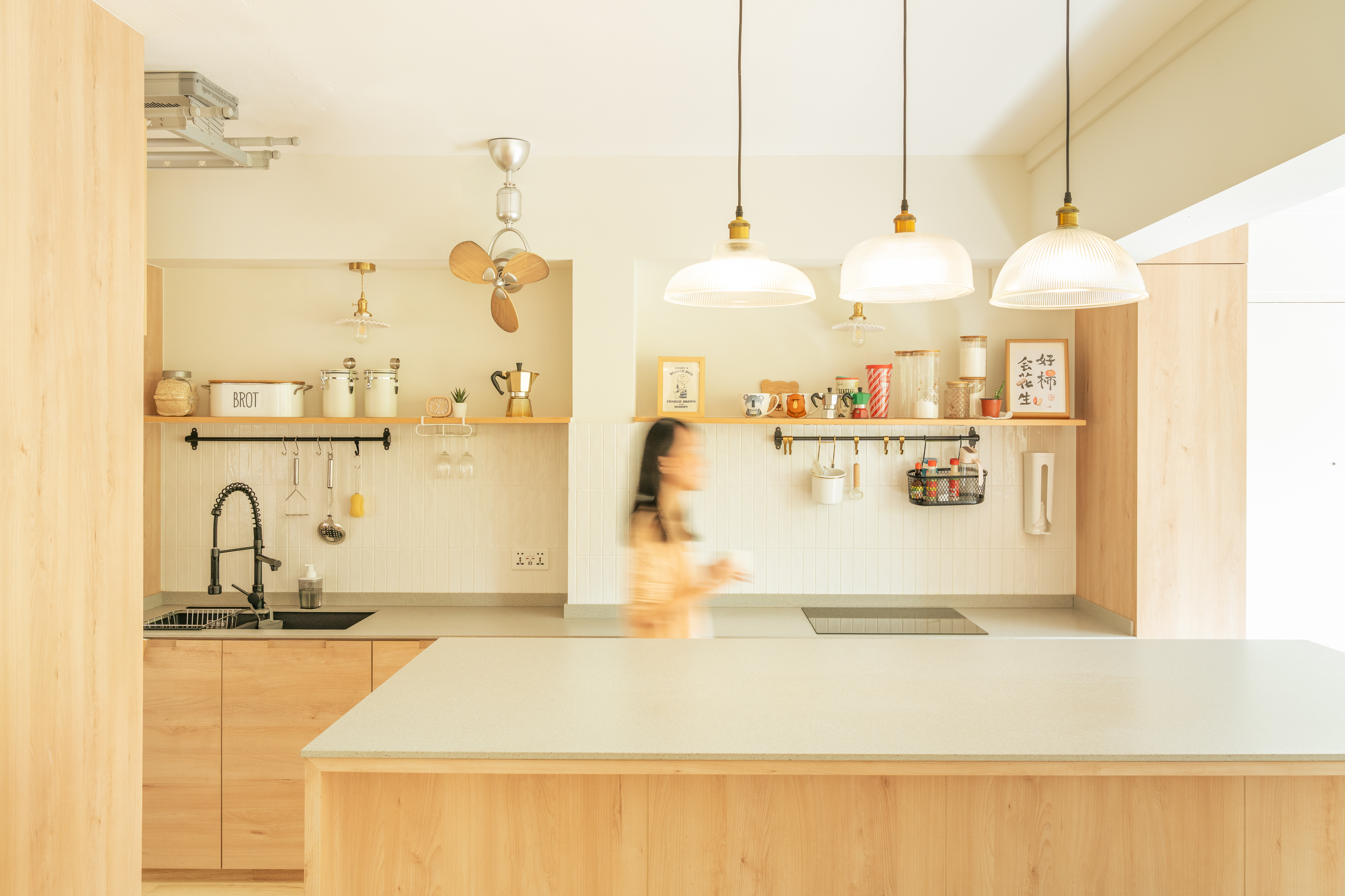 House designed to outsmart hungry dogs - Wooden kitchen cabinets, modern pendant lights, white tiled backsplash, black
