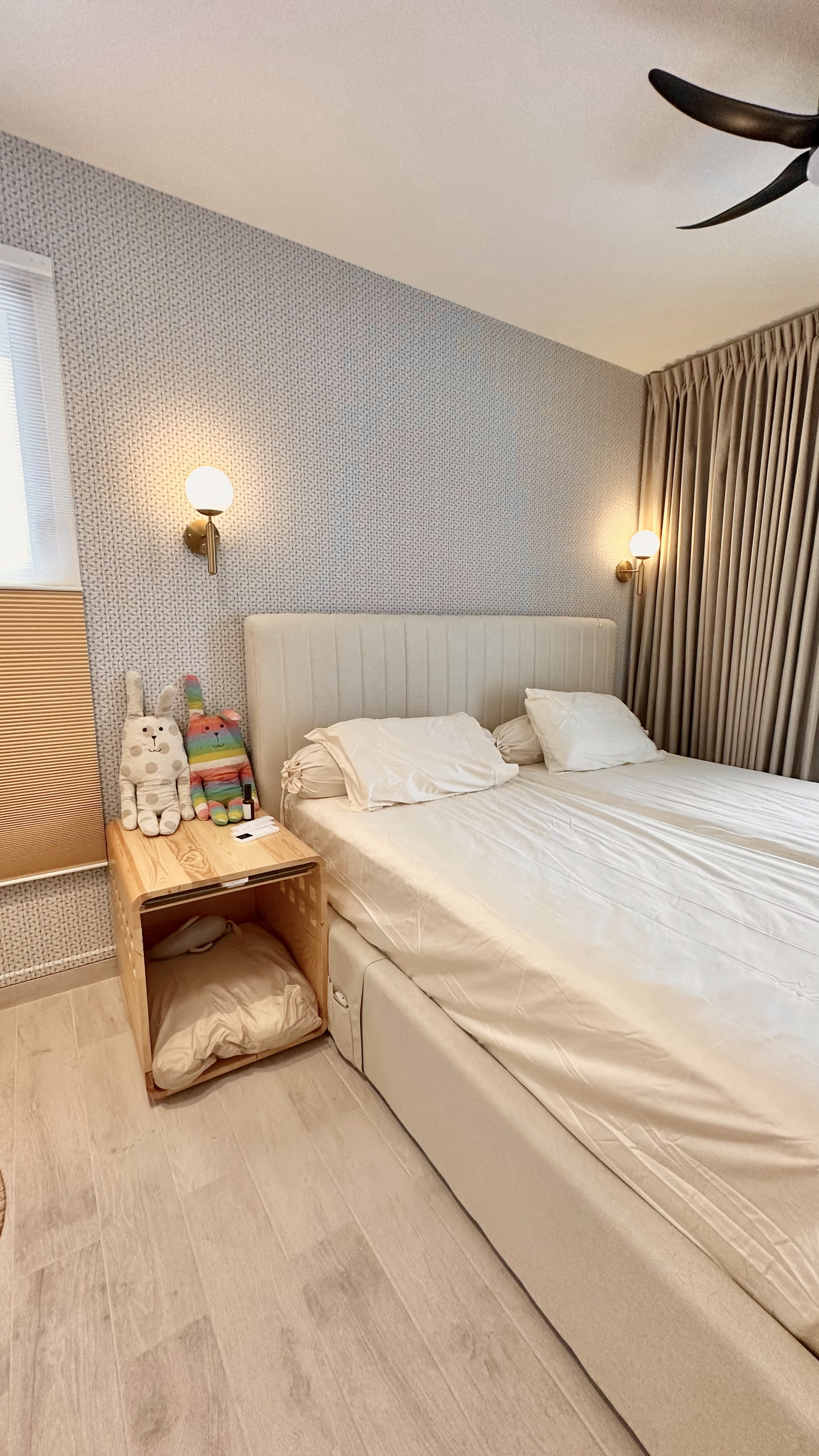 Welcome to oureastsideflat! ✨ - Light-colored, neatly made bed with white sheets and pillows, wooden nightstand with a