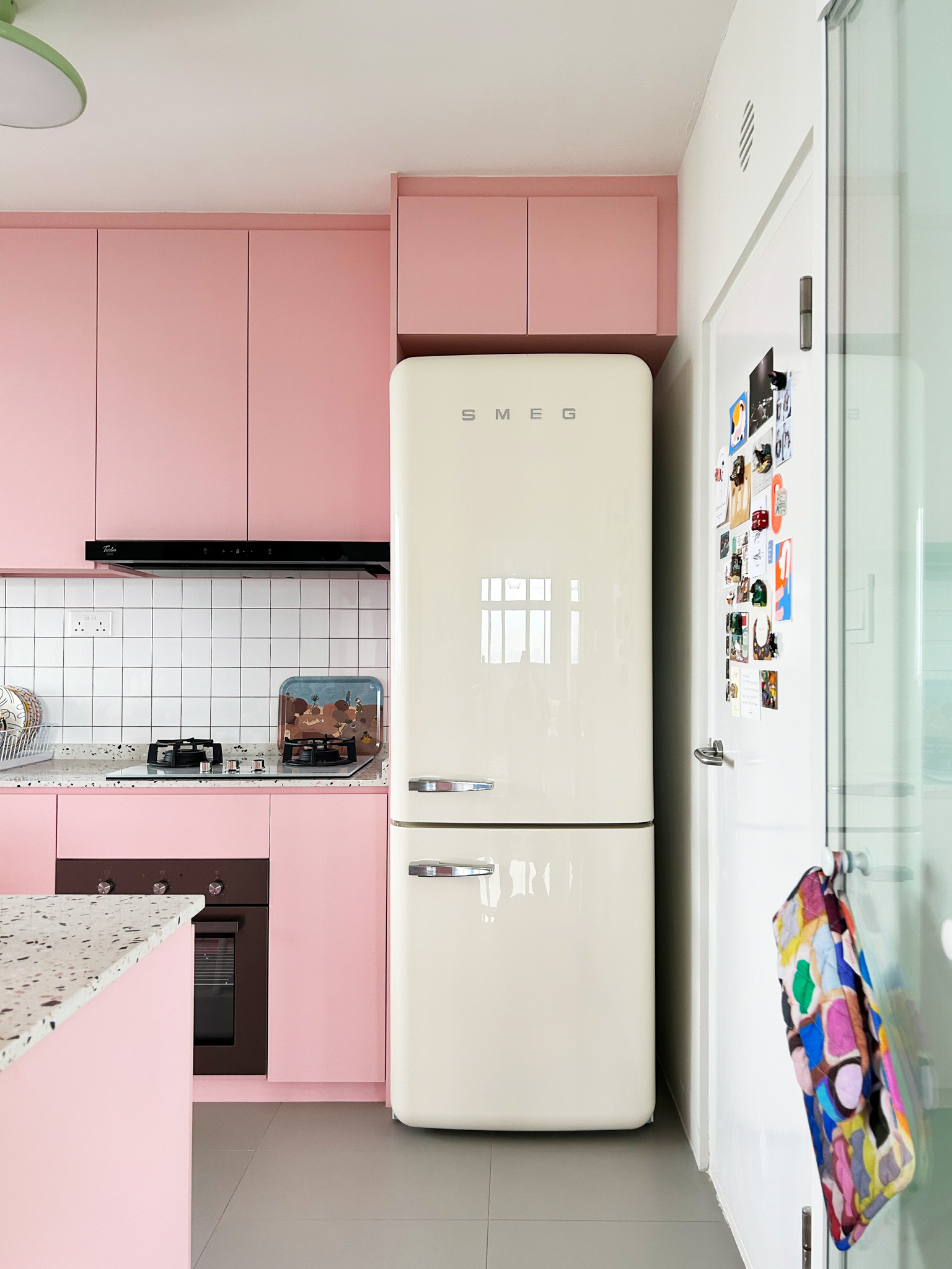 A quirky 93sqm home with pops of colour and 3 cattos - Pink kitchen with vintage refrigerator, white tiled backsplash, modern