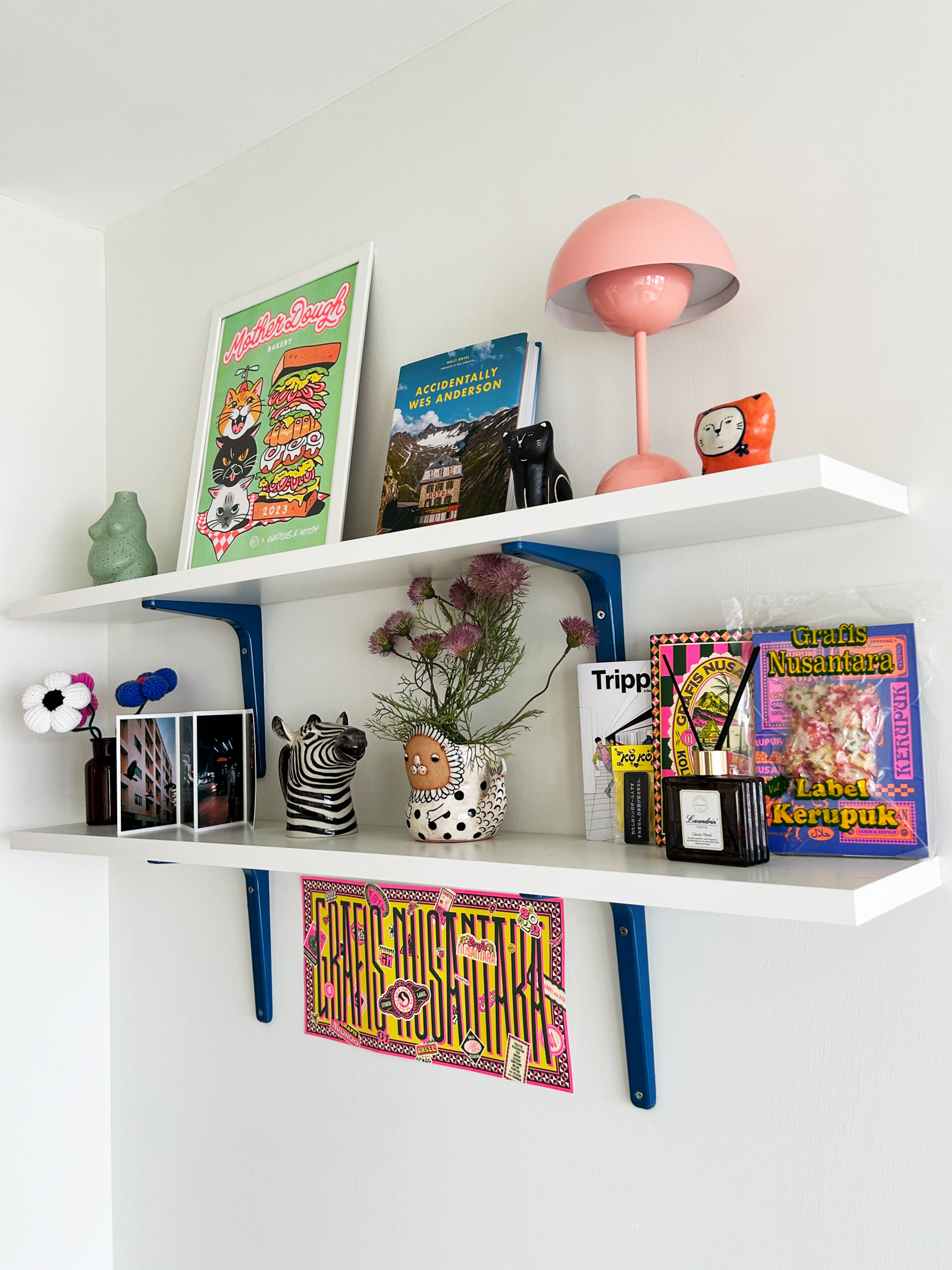 A quirky 93sqm home with pops of colour and 3 cattos - Wall-mounted shelves, eclectic decor, vibrant art, colorful posters