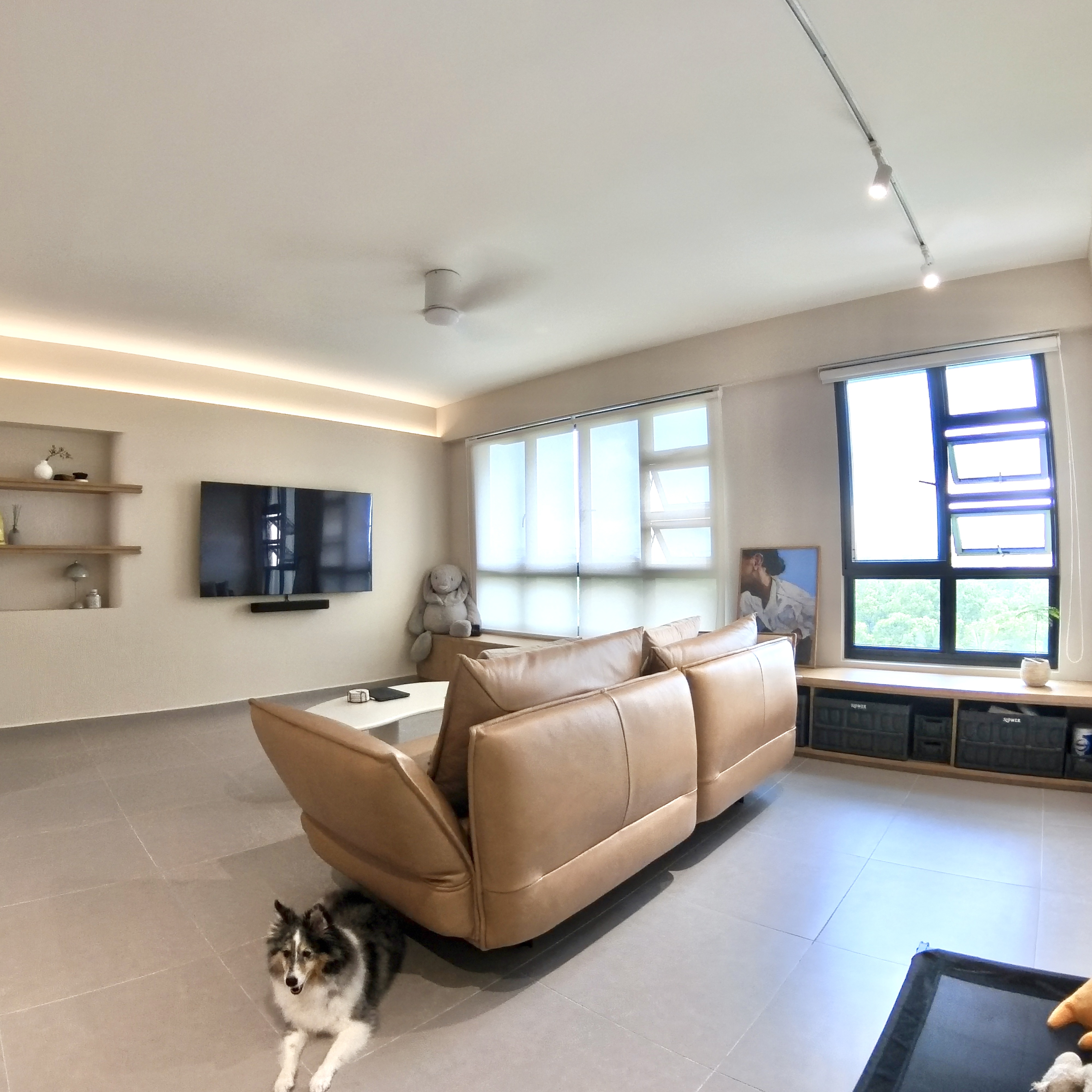 Come take a walk through our minimalist home - Modern living room with beige walls, large window with blinds, sleek