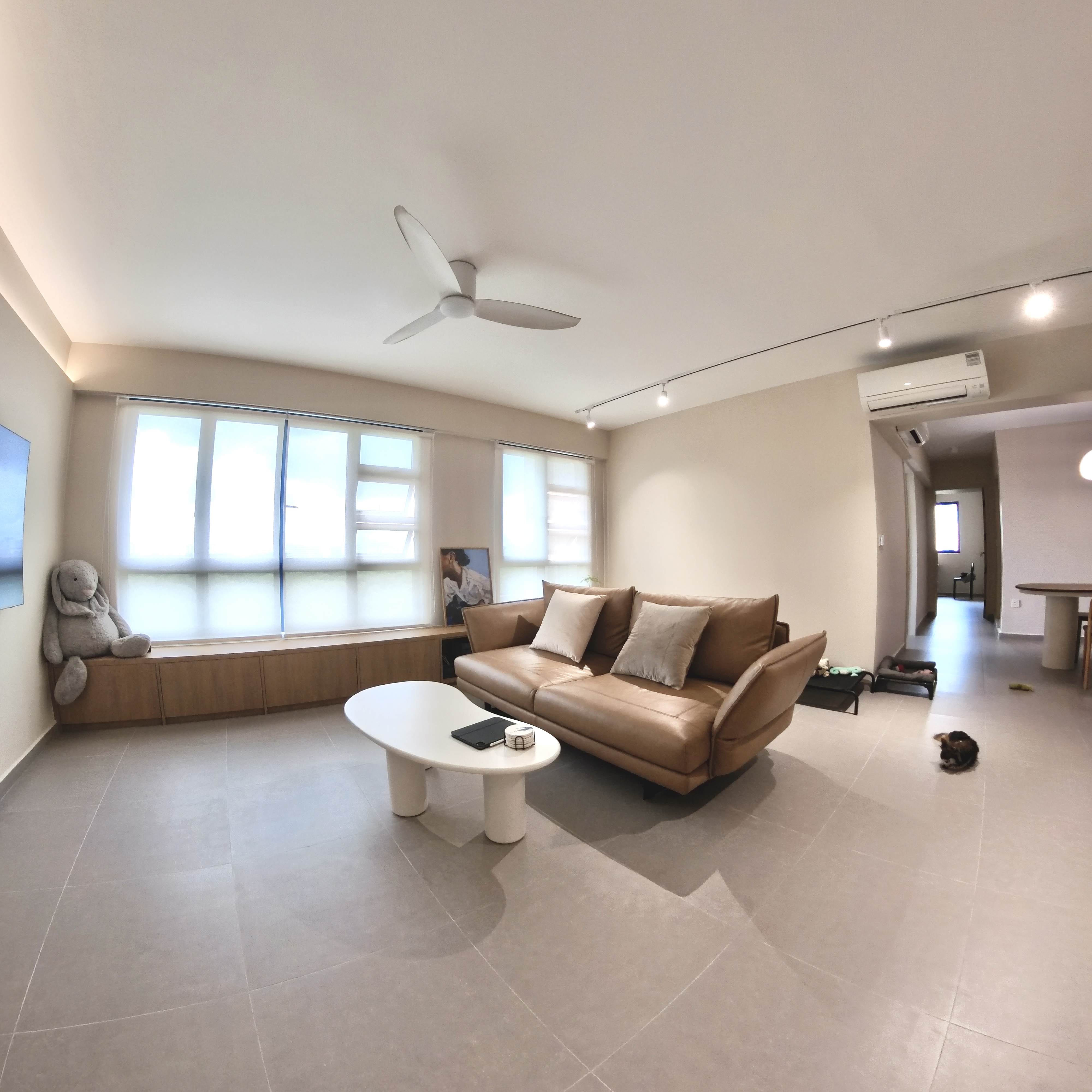 Come take a walk through our minimalist home - Modern living room with large windows, beige walls, contemporary furniture