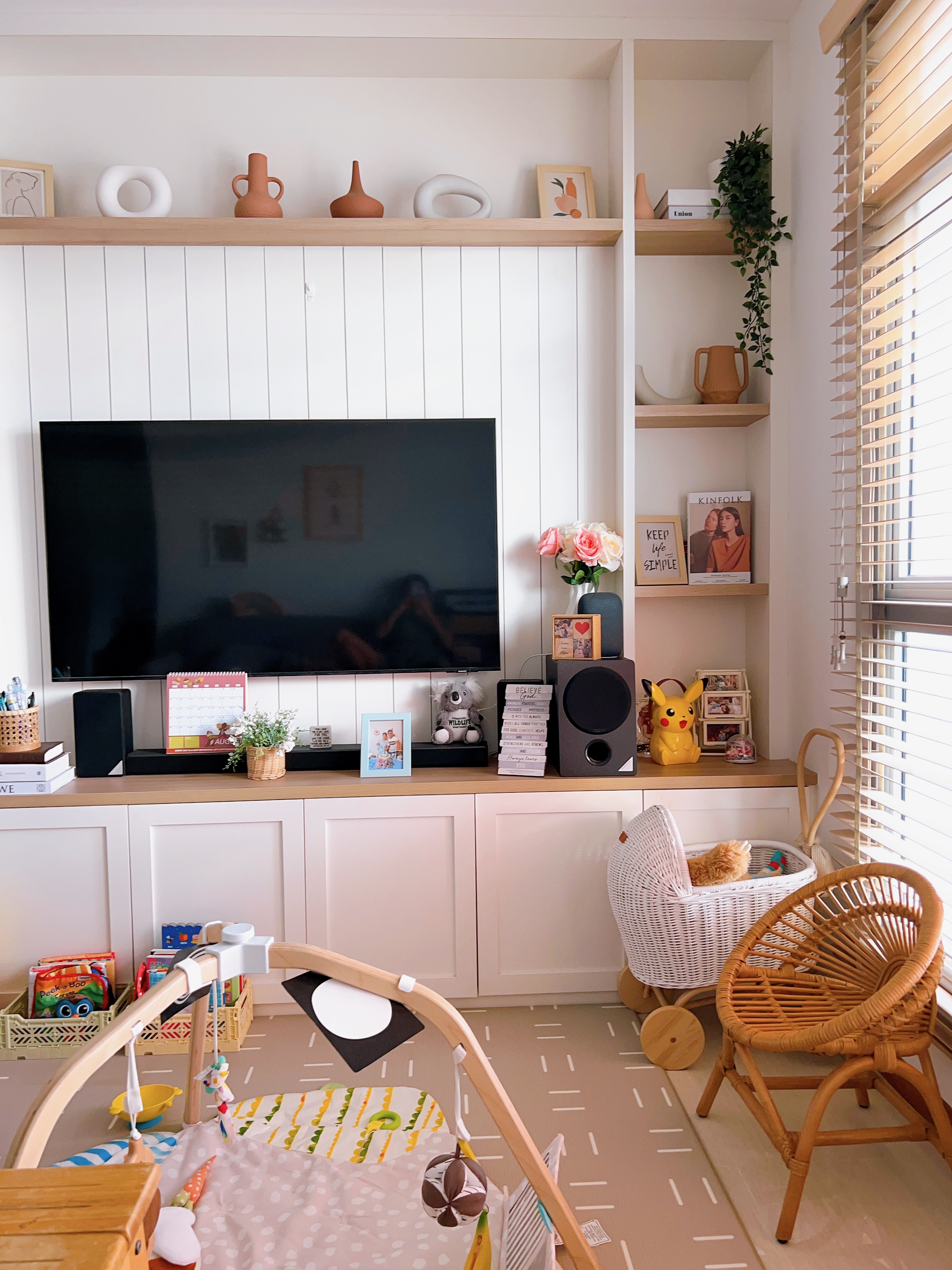 Living room: Multifunctional space that changes through the seasons  - Wooden shelves, white paneled wall, modern decor, cozy