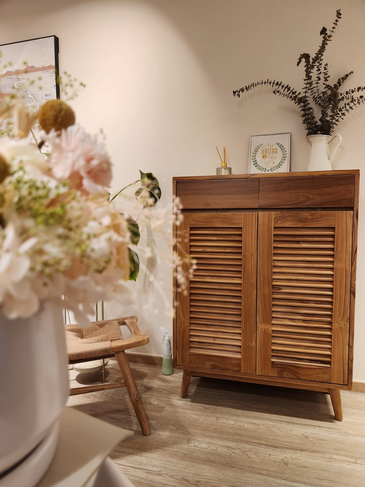 Customized Teak Grade A shoe cabinet and woven stool - Wooden cabinet with louvered doors, beige wooden floor, soft lighting