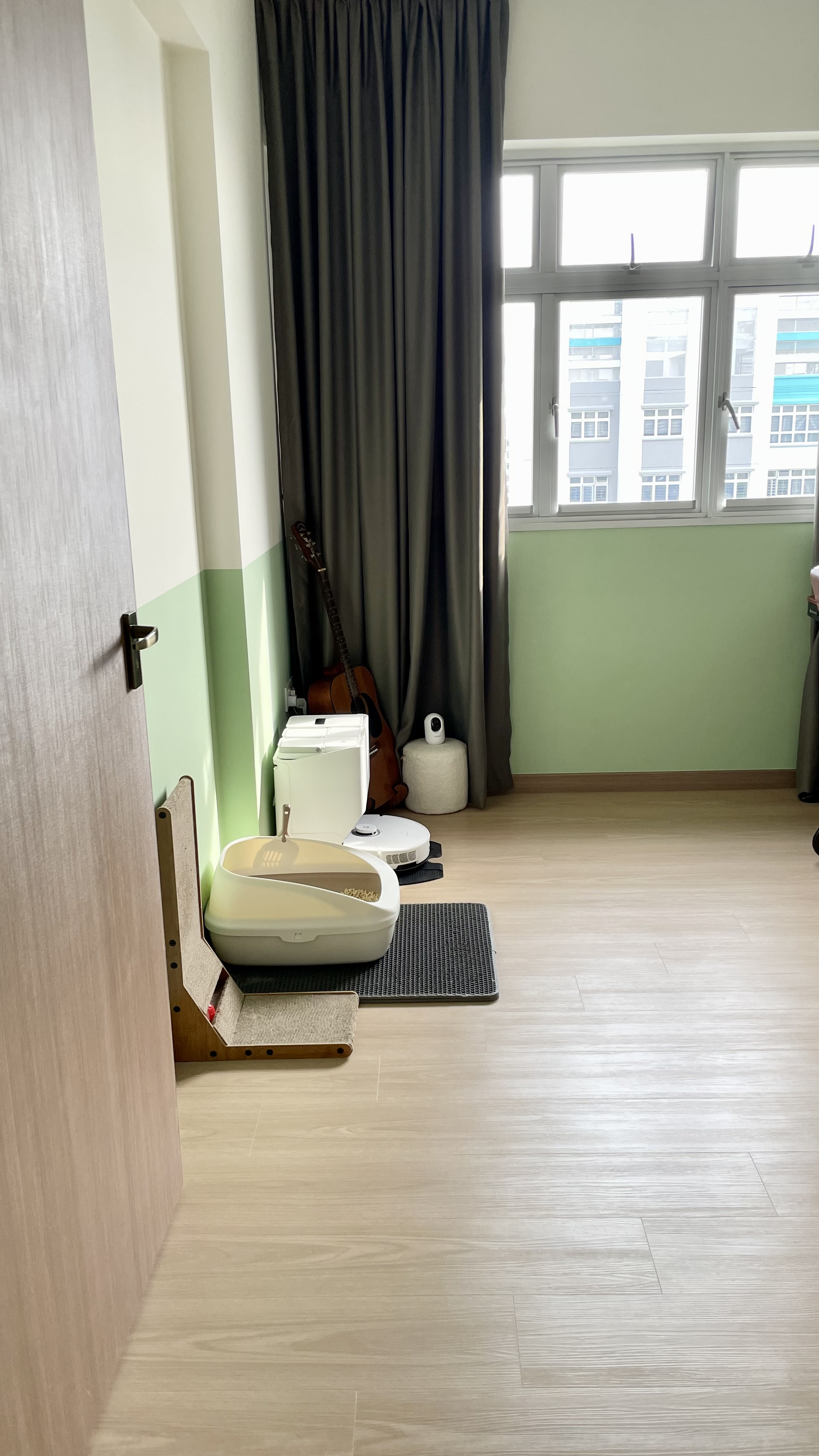 Must-have for busy homeowners - Robot Vacuum - Wooden floor, light green walls, sliding door, white cat tree, beige carpet