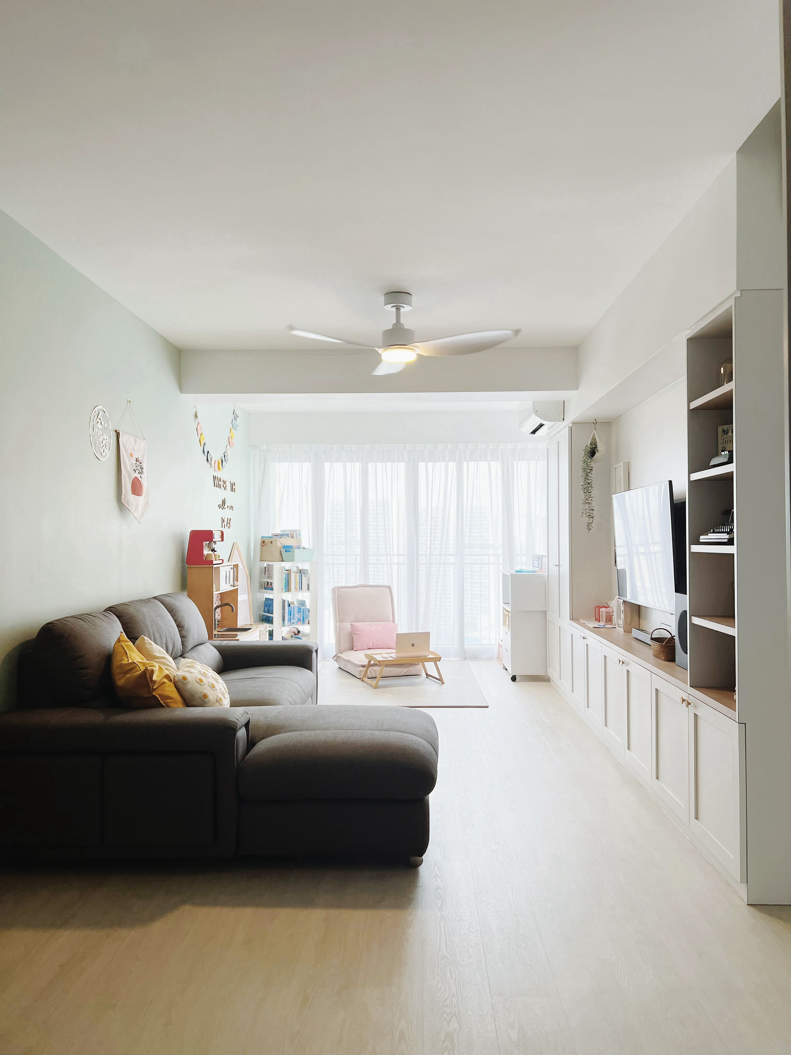 Designing a Multi-Functional Living Room with Kids - Light-colored walls, modern ceiling fan, cozy living room, gray