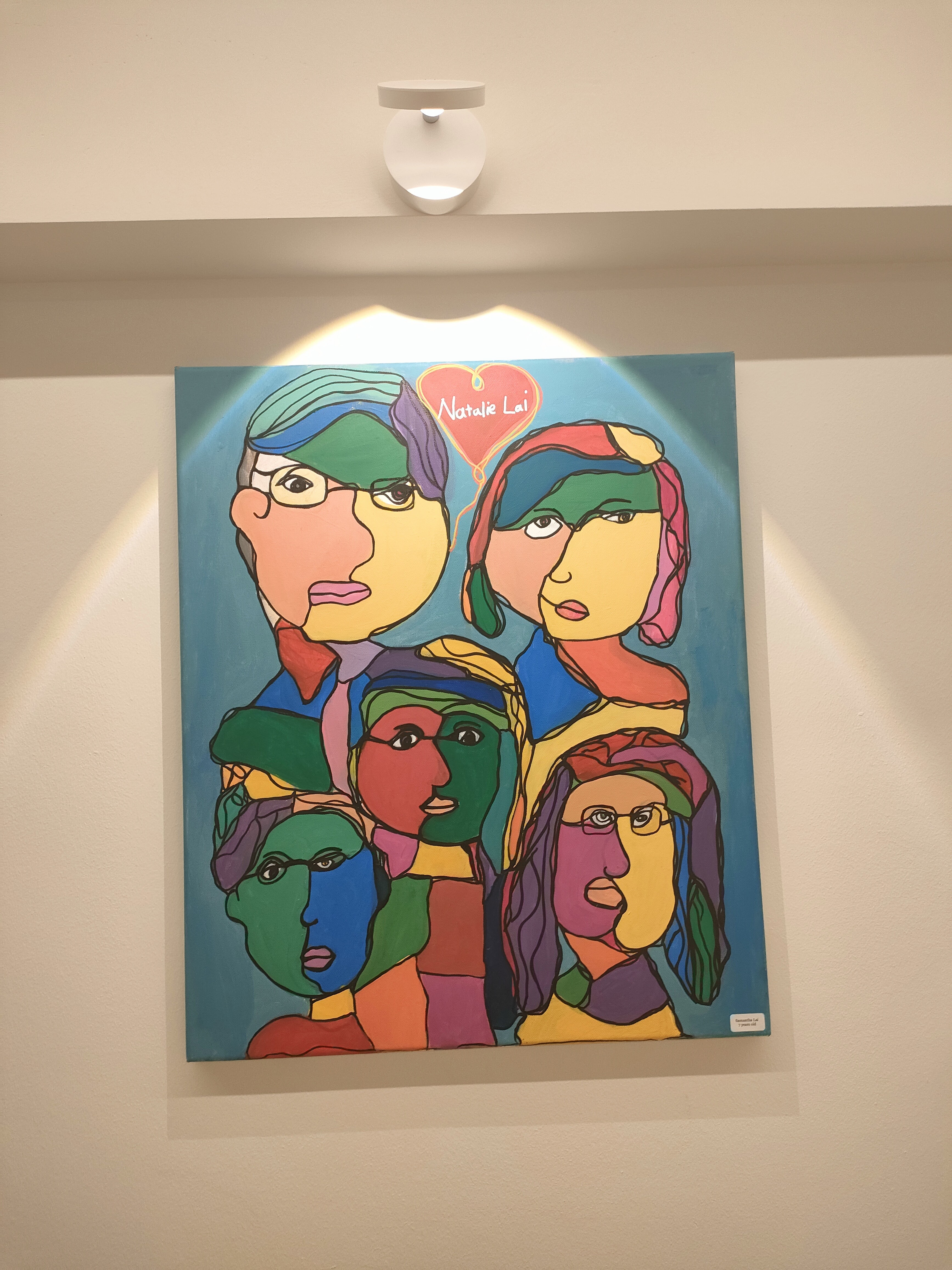 Living room where we gather for family bonding - Vibrant, abstract painting featuring stylized faces with diverse colors and