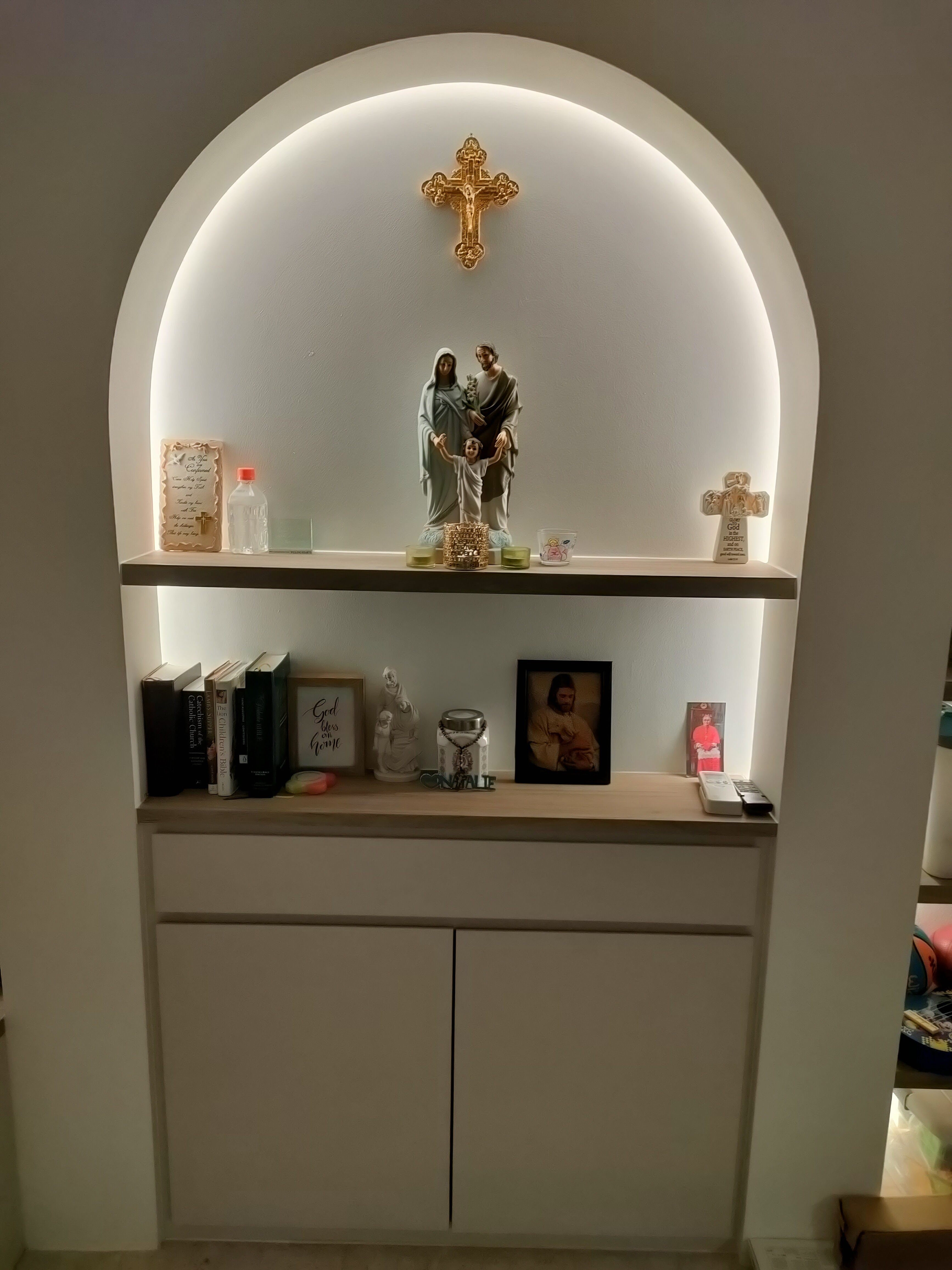Living room where we gather for family bonding - White arched alcove, soft lighting, religious icon, statue of Mary and