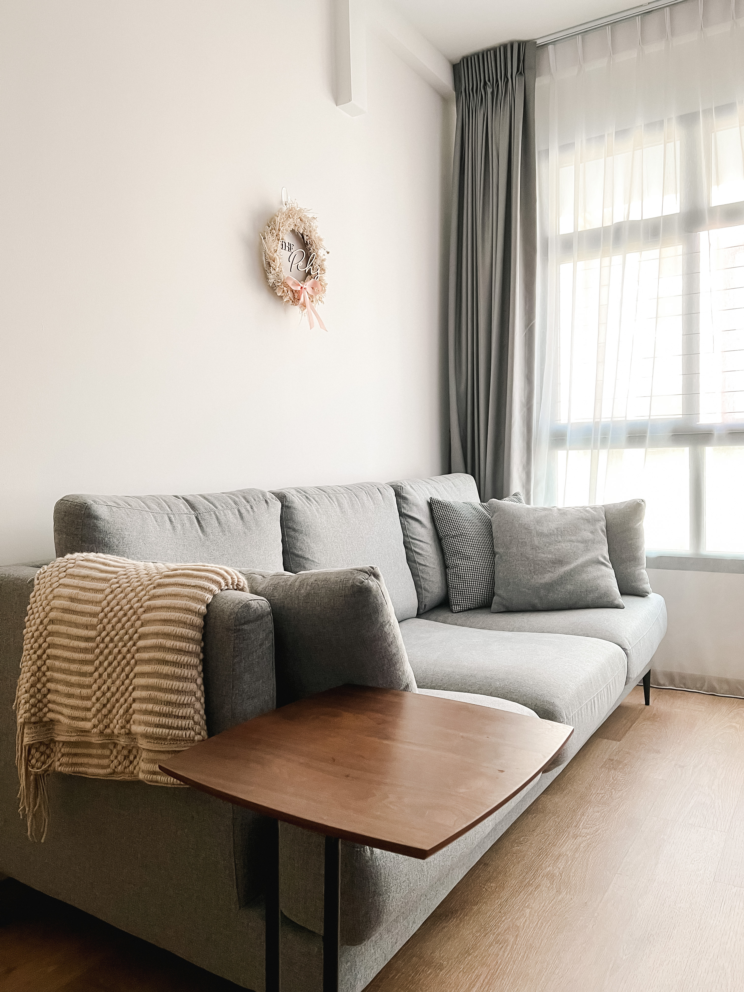 Living Room - Sanctuary of Style and Comfort - Light gray sofa, beige knitted throw, wooden coffee table, soft natural light