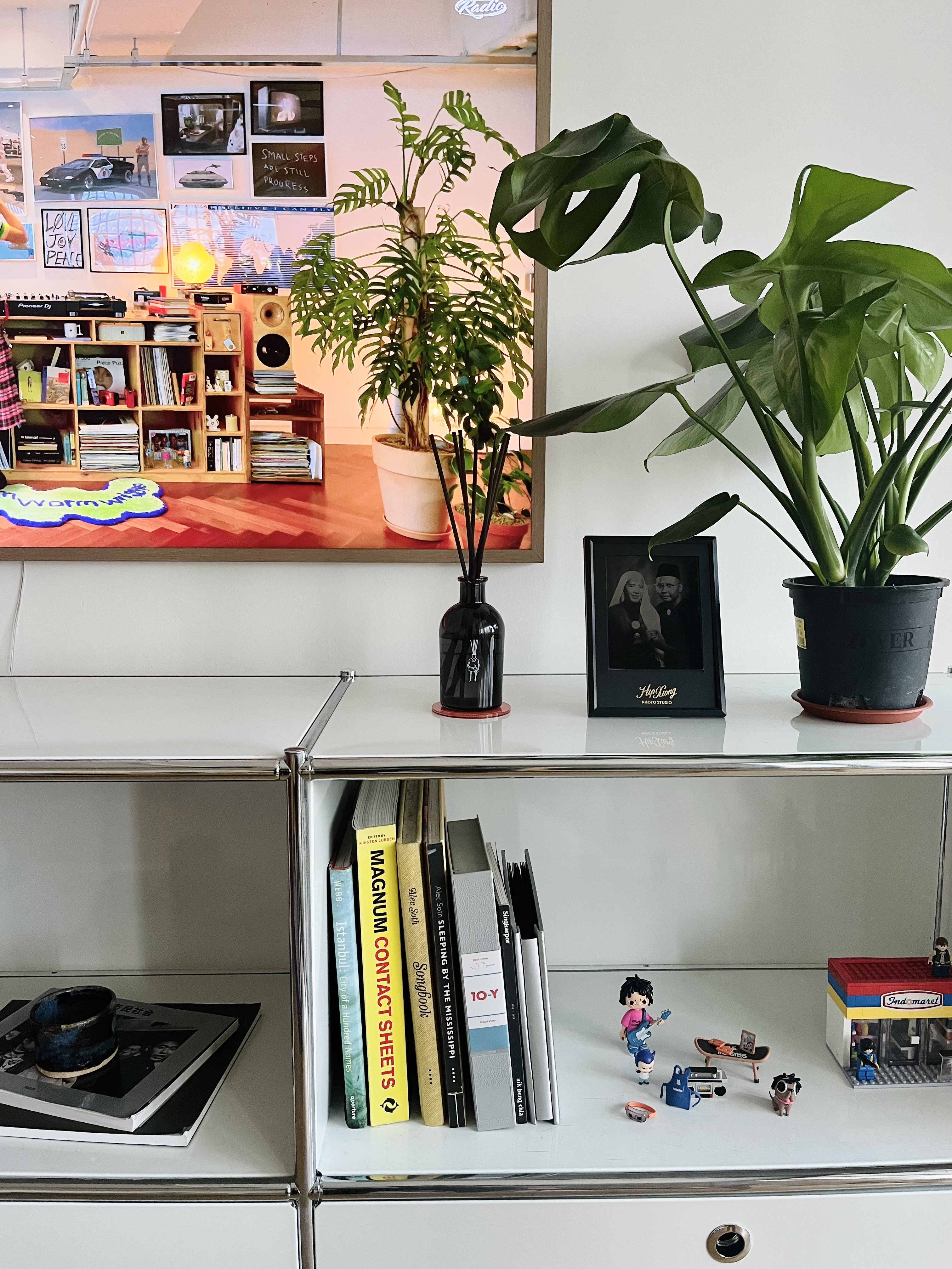 Living in Colours - Organized workspace, modern decor, bookshelf, plants, music equipment, colorful artwork, indoor plants