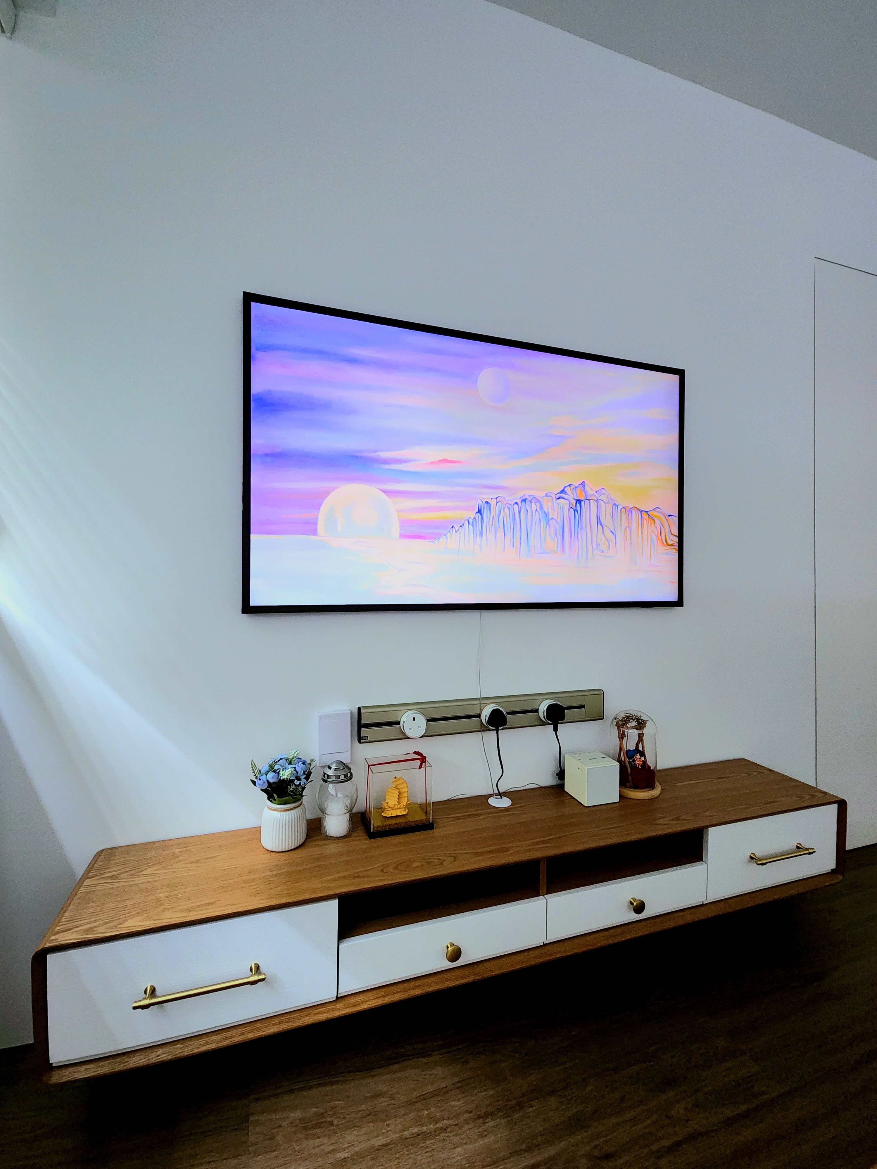 All in one living room: Dry kitchen, living area & chill space  - Large wall-mounted TV displaying vibrant sunset scene