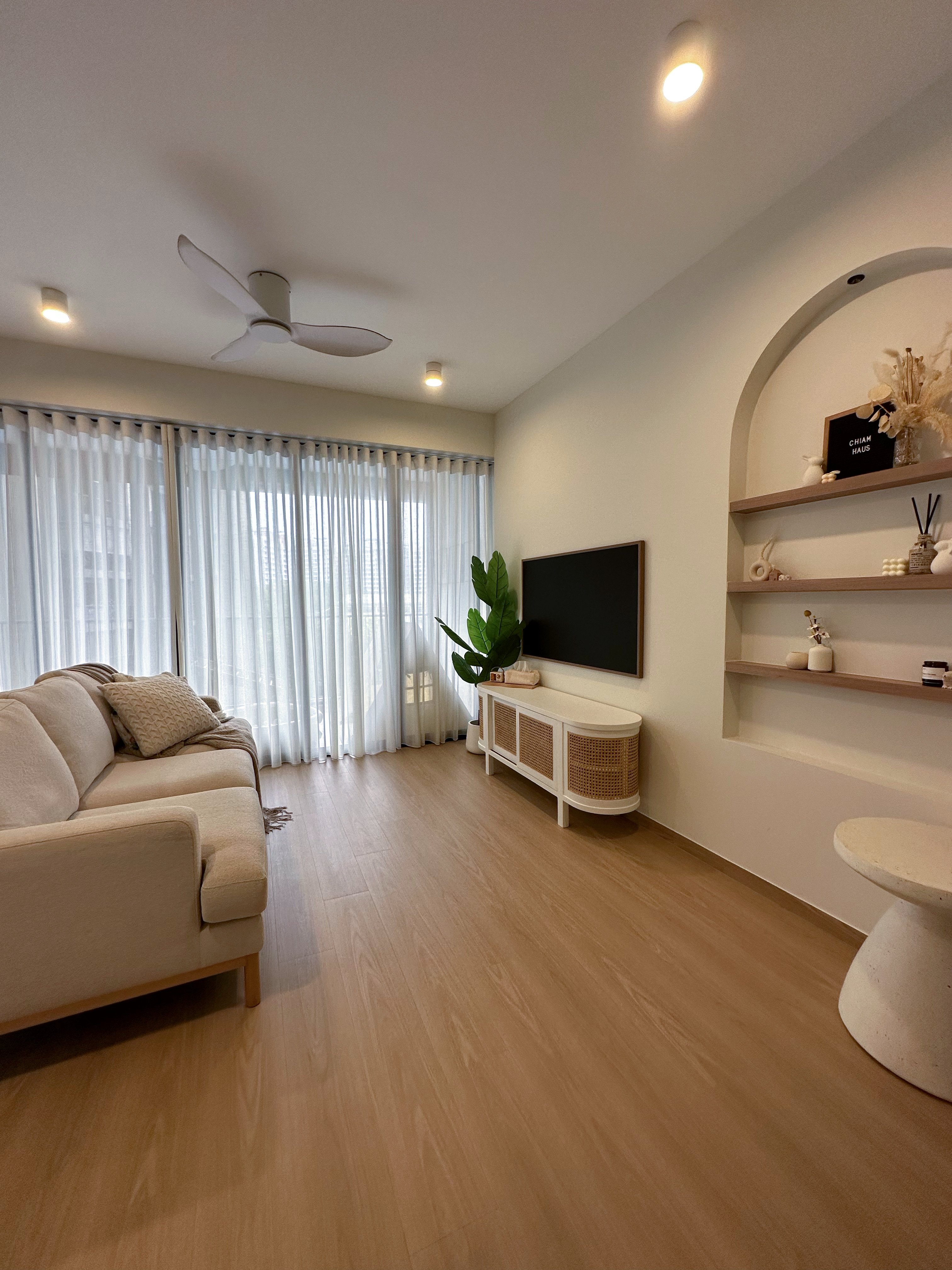 Living Room - Our favourite space in the entire house - Modern living room with beige sofa, large window with sheer curtains