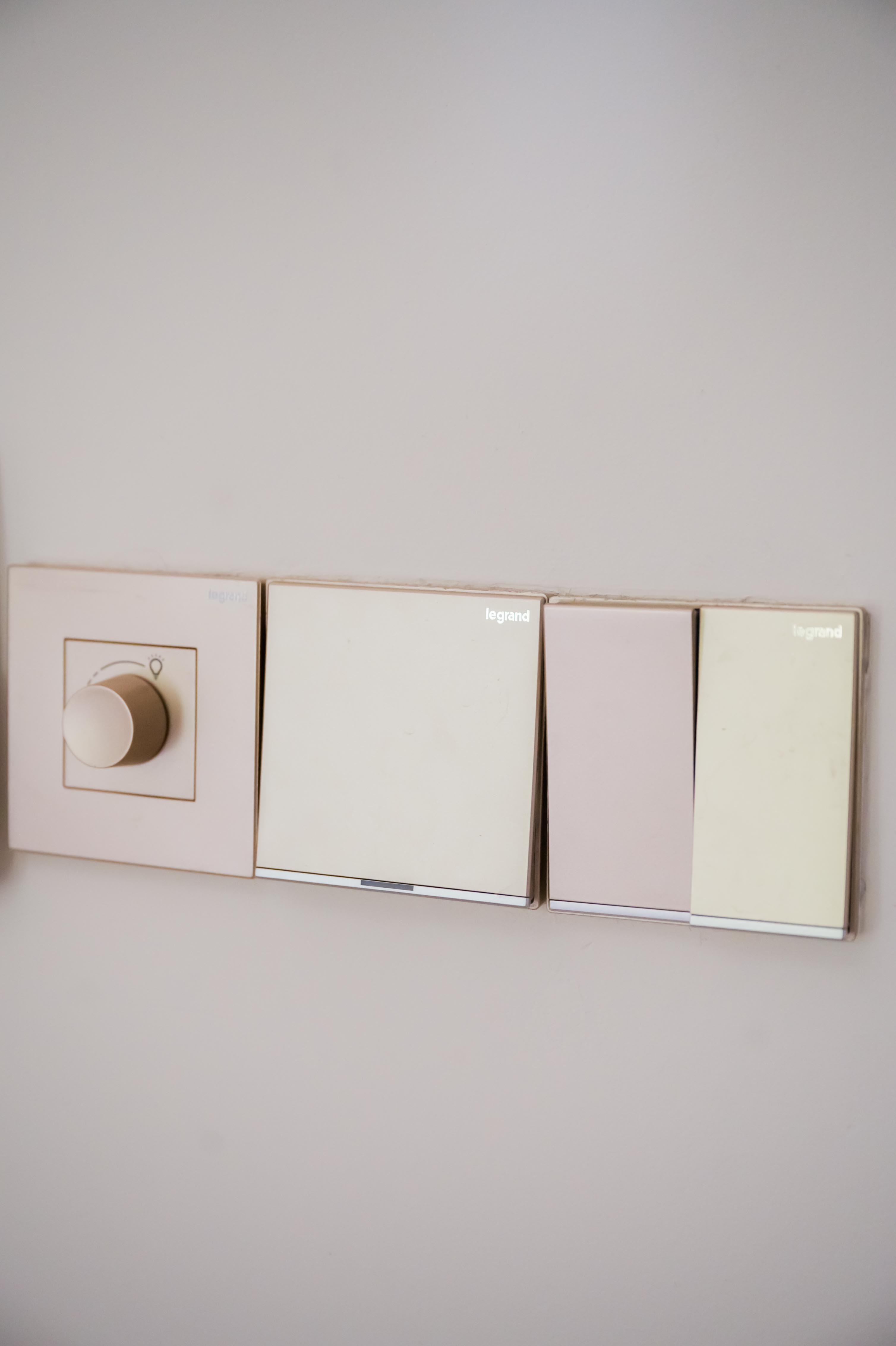 Minimal and clutter free living room - Wall-mounted control panel, minimalist design, soft pastel colors, three switches