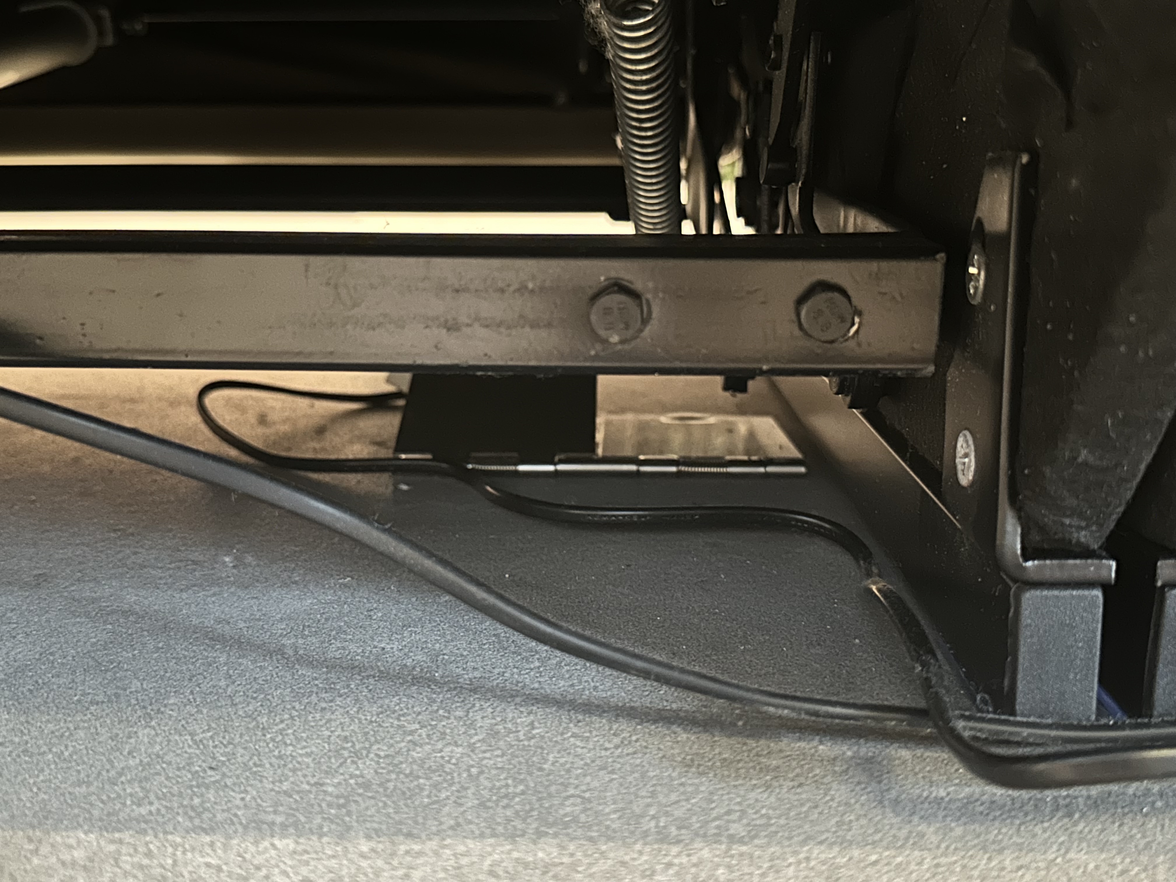 Introducing the Living Room of resort.d.lala - Underneath the chassis, a black cable runs along the floor, connected to a