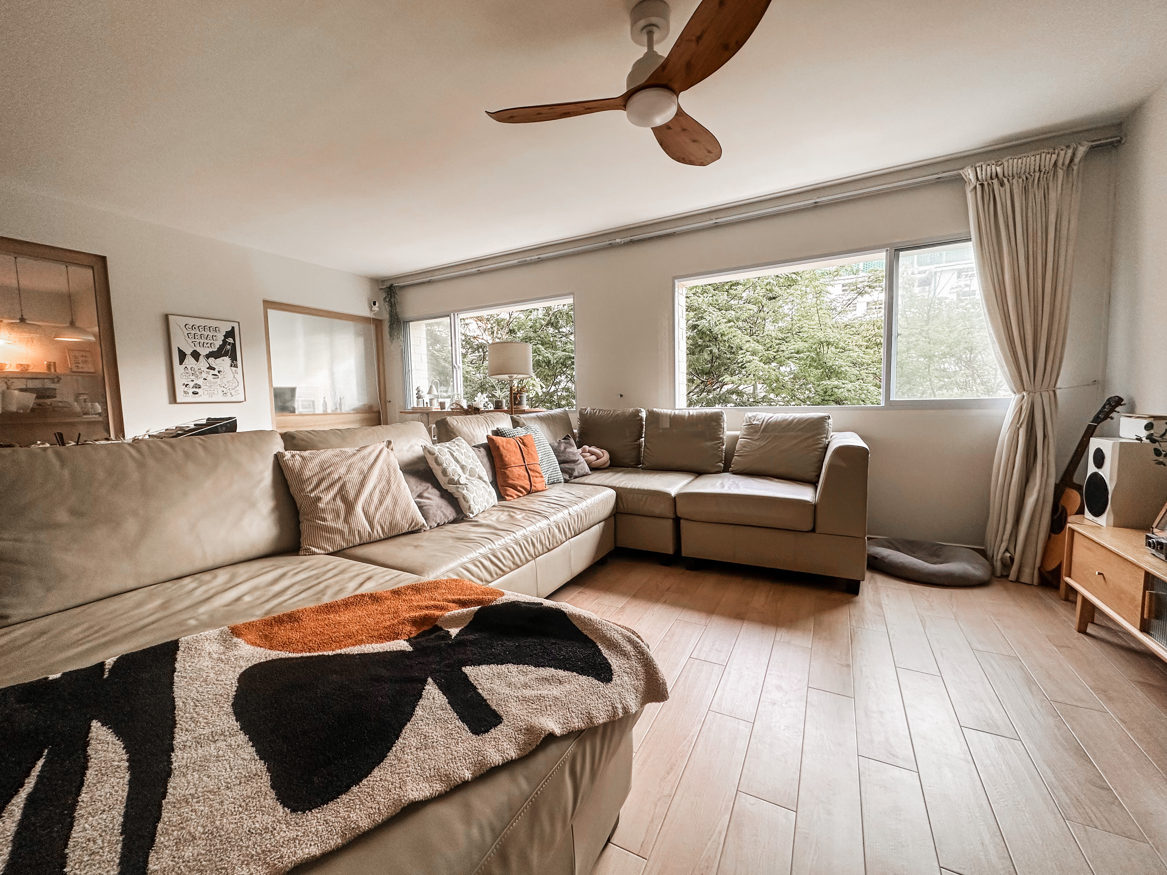 Styling a dog, baby, plant babies friendly living room - Modern living room with beige leather sofa, large window with