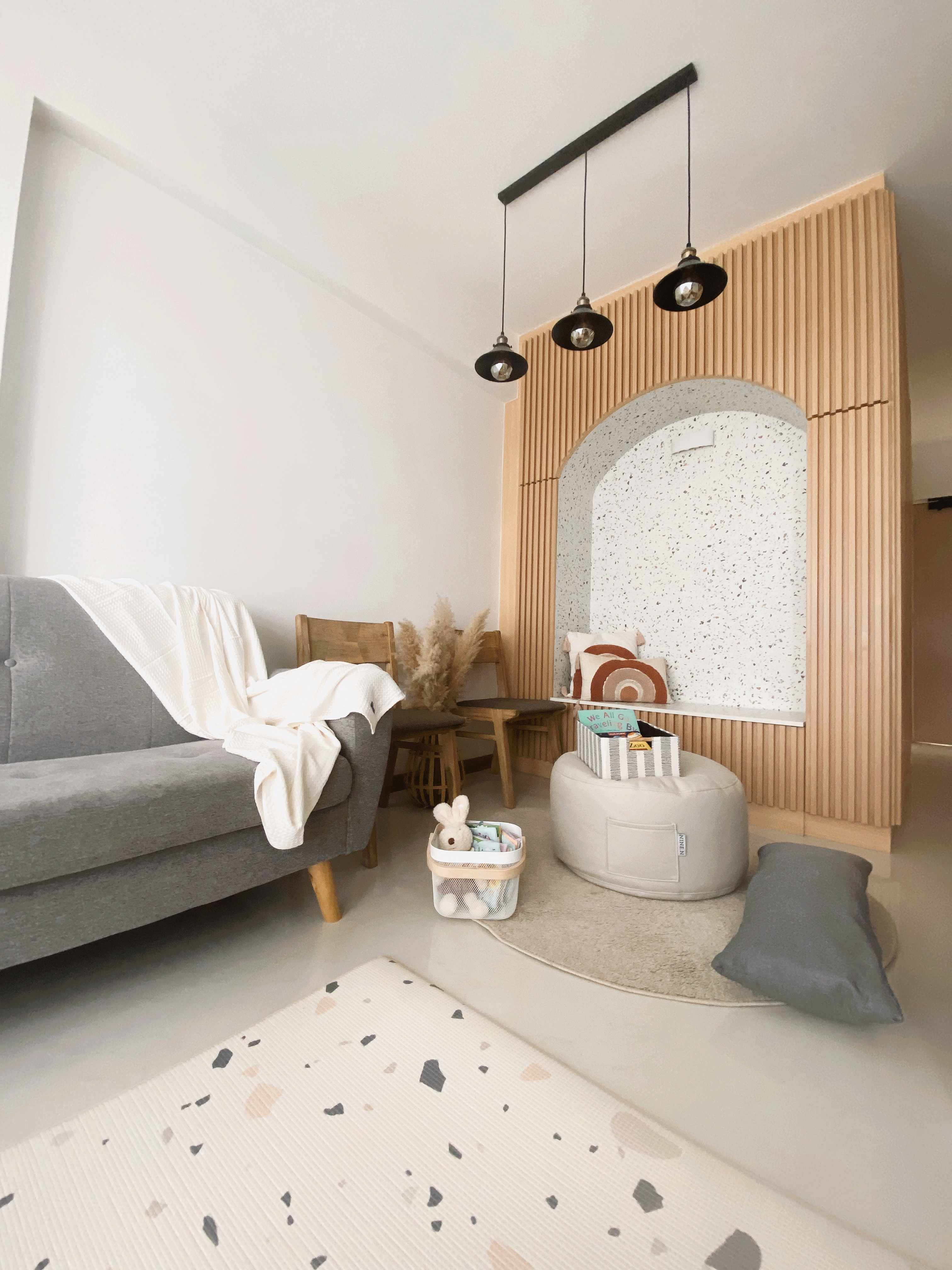 Style + Comfort In This Multi-Functional Living Room - modern living room, cozy seating, gray sofa, white blanket, wooden