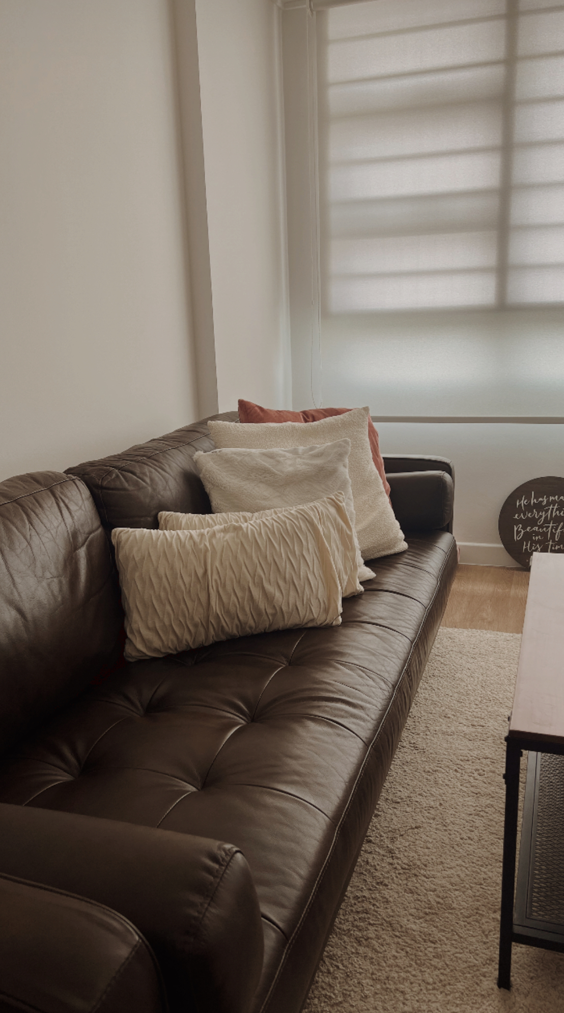 Our warm & comforting Japandi-inspired living room - Leather sofa, beige and white pillows, brown leather upholstery, window