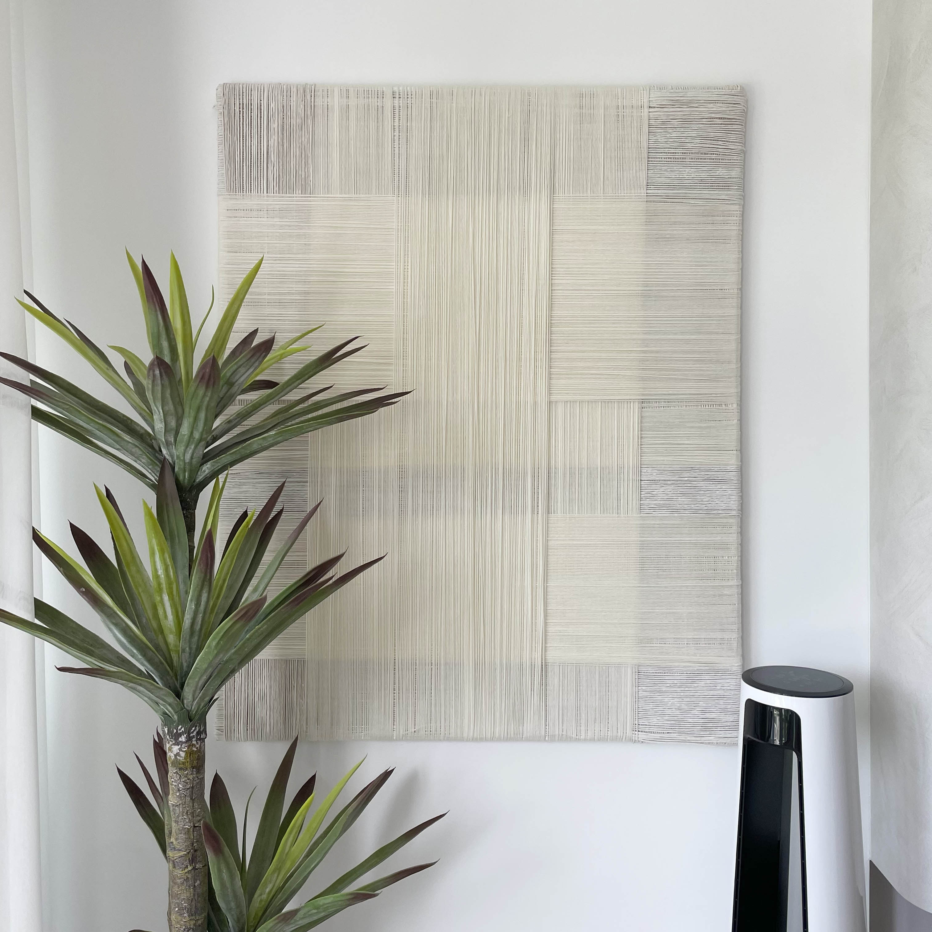 Housewarming - Japandi-inspired home - Modern minimalist decor, abstract wall art, textured bamboo panel, potted plant with