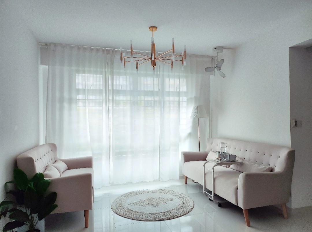 Play around with the living room - Light-filled living room with soft, natural light streaming through sheer white curtains.