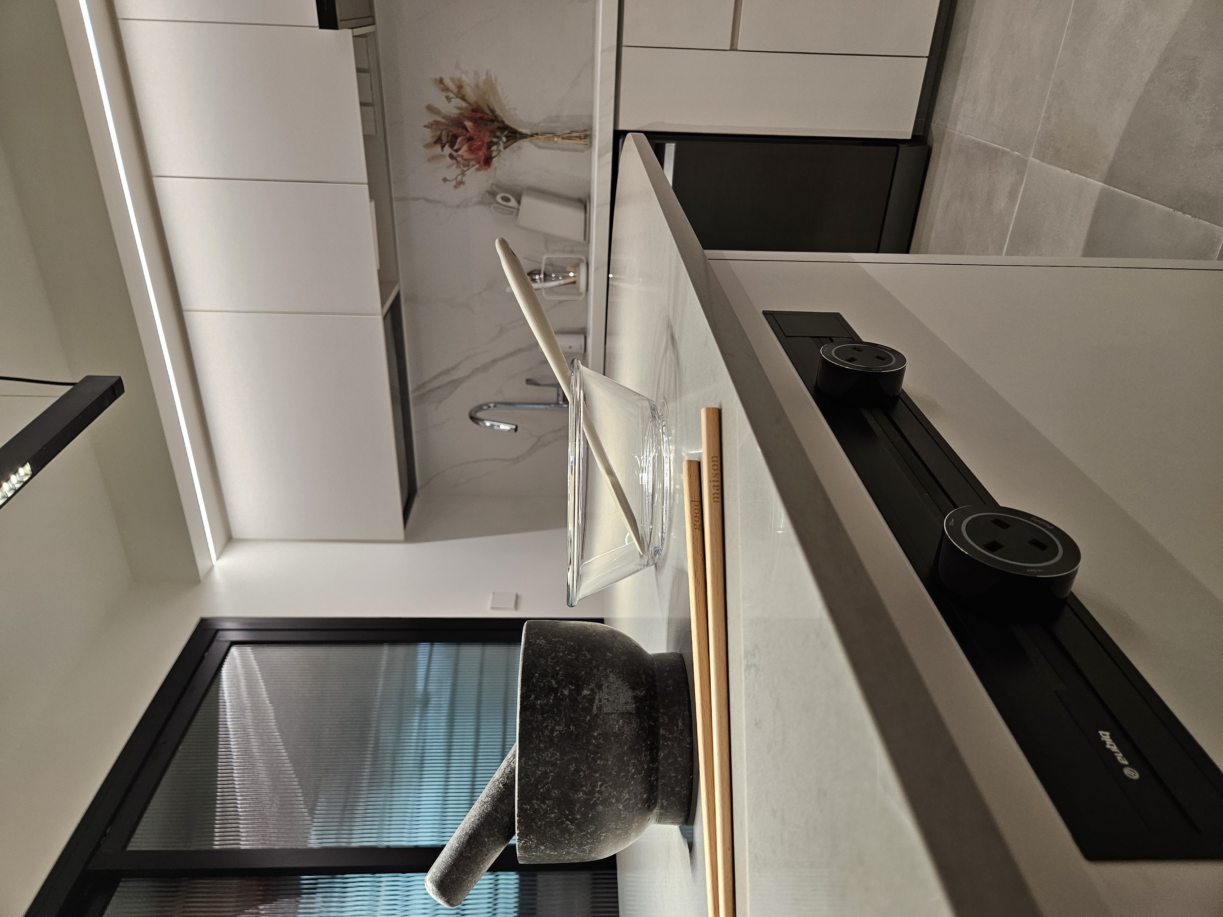 Oddly Shaped Dining Table and Island - modern kitchen, minimalist design, sleek appliances, white cabinets, floating shelf