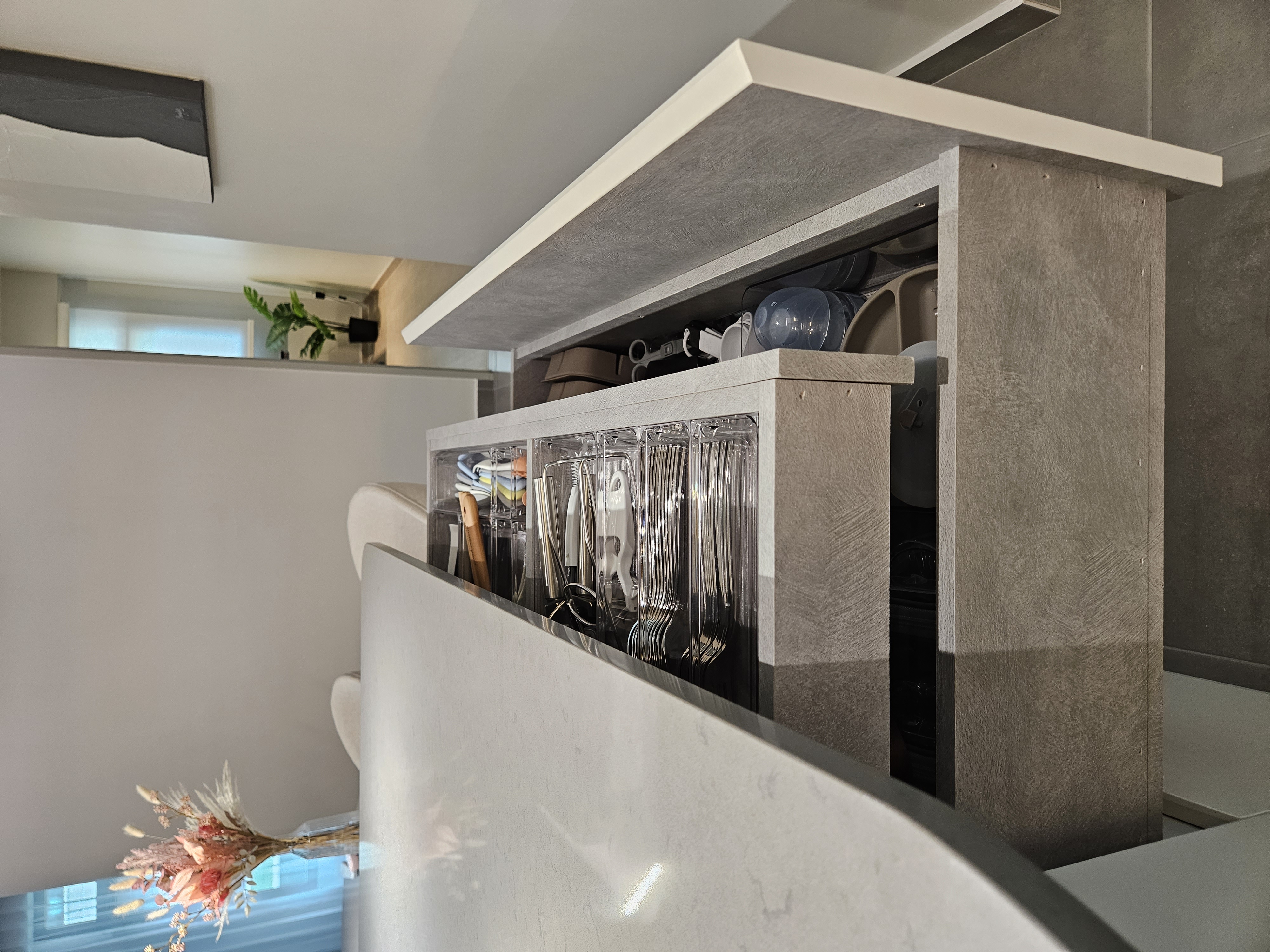 Oddly Shaped Dining Table and Island - modern kitchen countertop, sleek cabinets, glassware storage, minimalist design