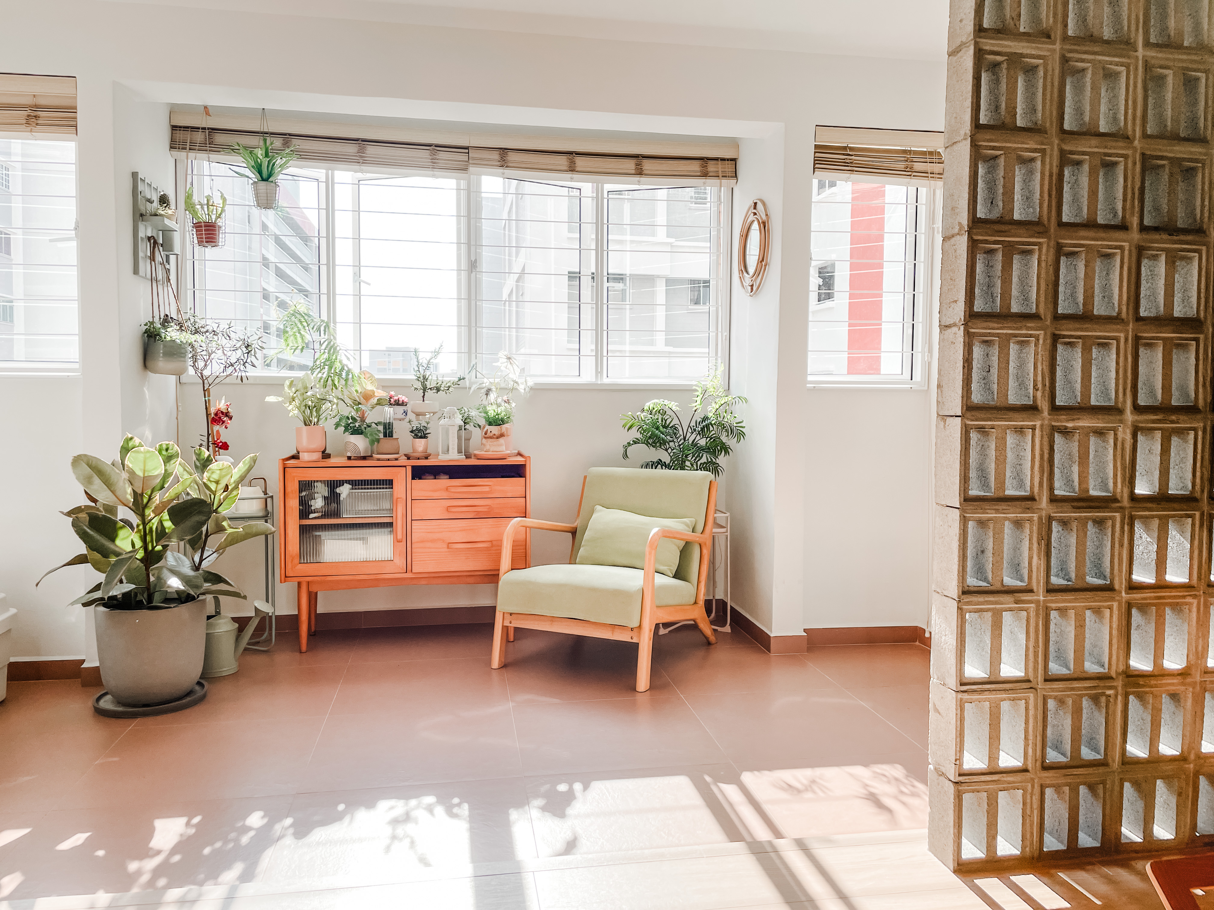 House-Hunting: Seeking a Spacious Home for our Growing Family Of Four  - Bright room with large windows, green plants, wooden