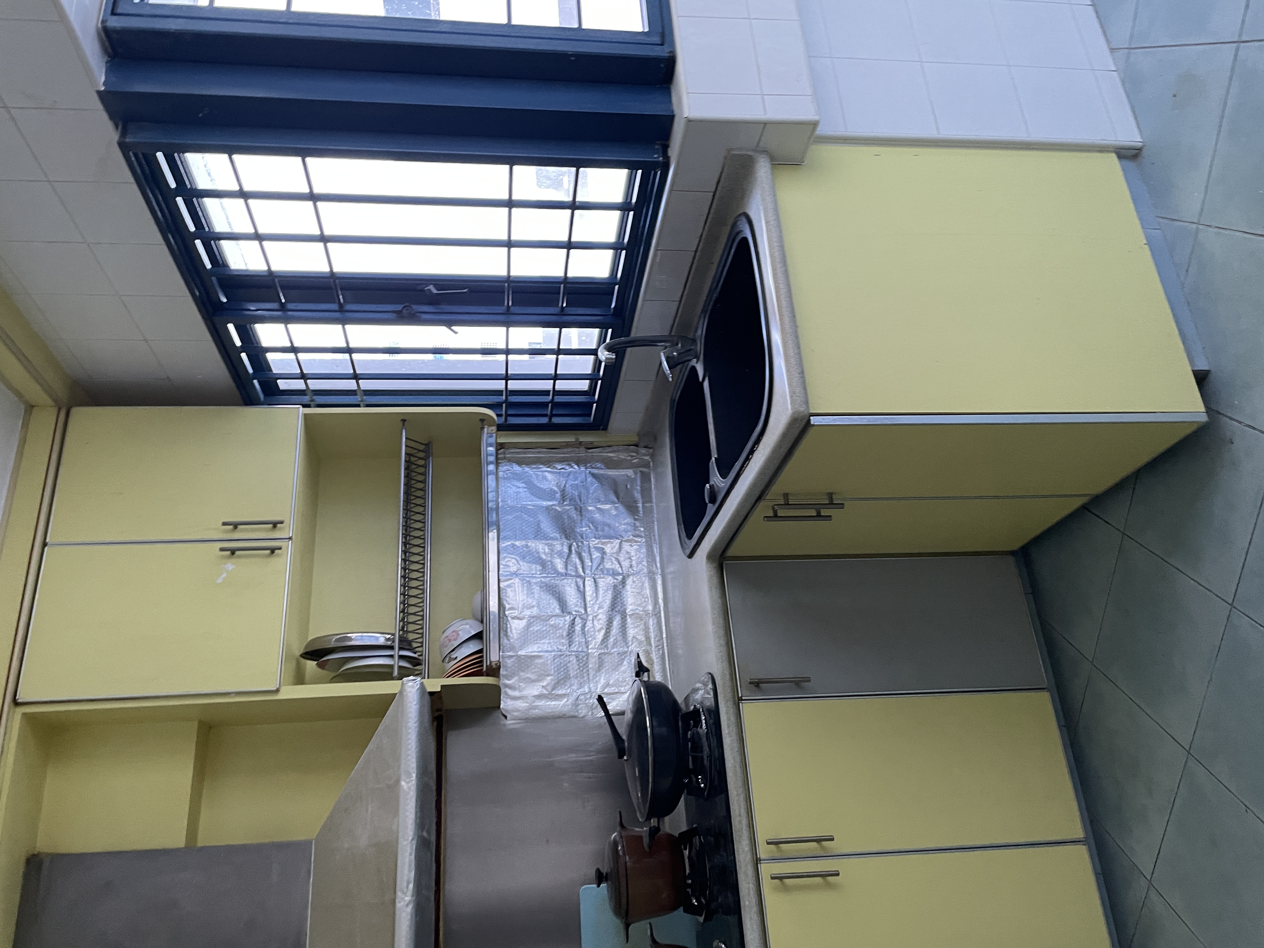 House-Hunting: Seeking a Spacious Home for our Growing Family Of Four  - yellow kitchen cabinets, tiled walls, stainless