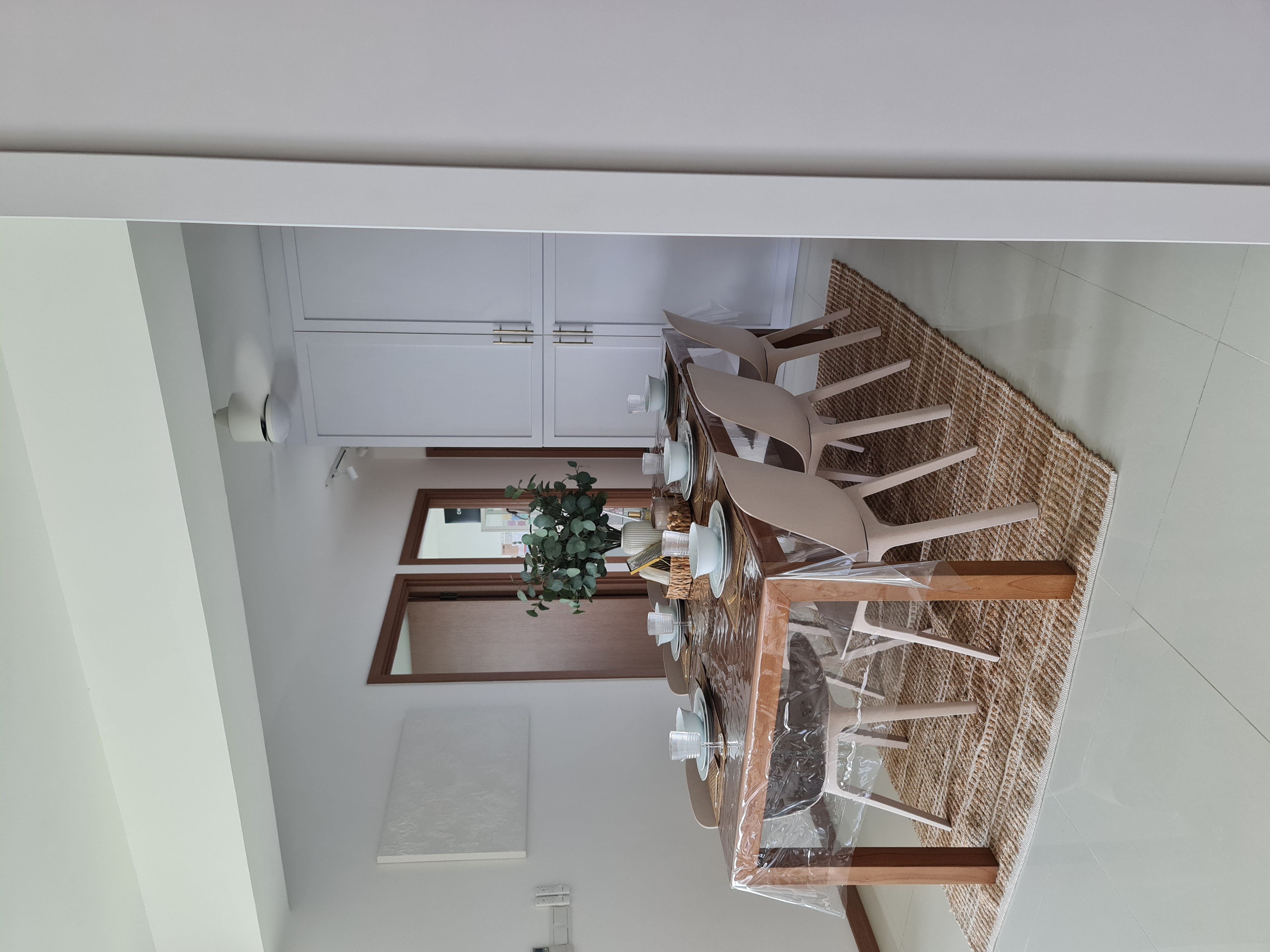 Dining in love - Modern dining room, minimalist design, white cabinets, dining table, wooden chairs, potted plant, woven rug