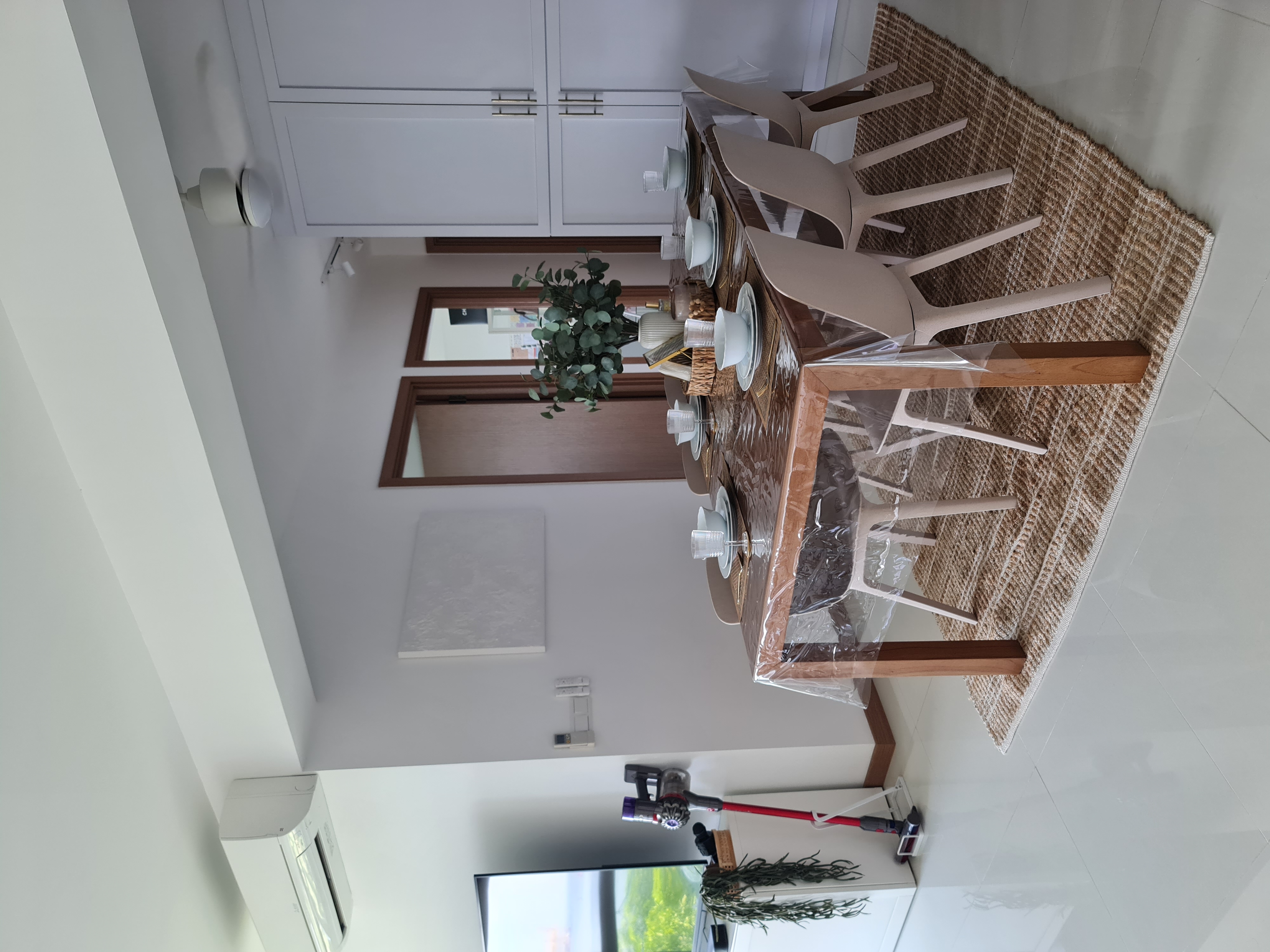 Dining in love - Modern dining room with sleek furniture, minimalist decor, dining table set with plates, glasses, and a