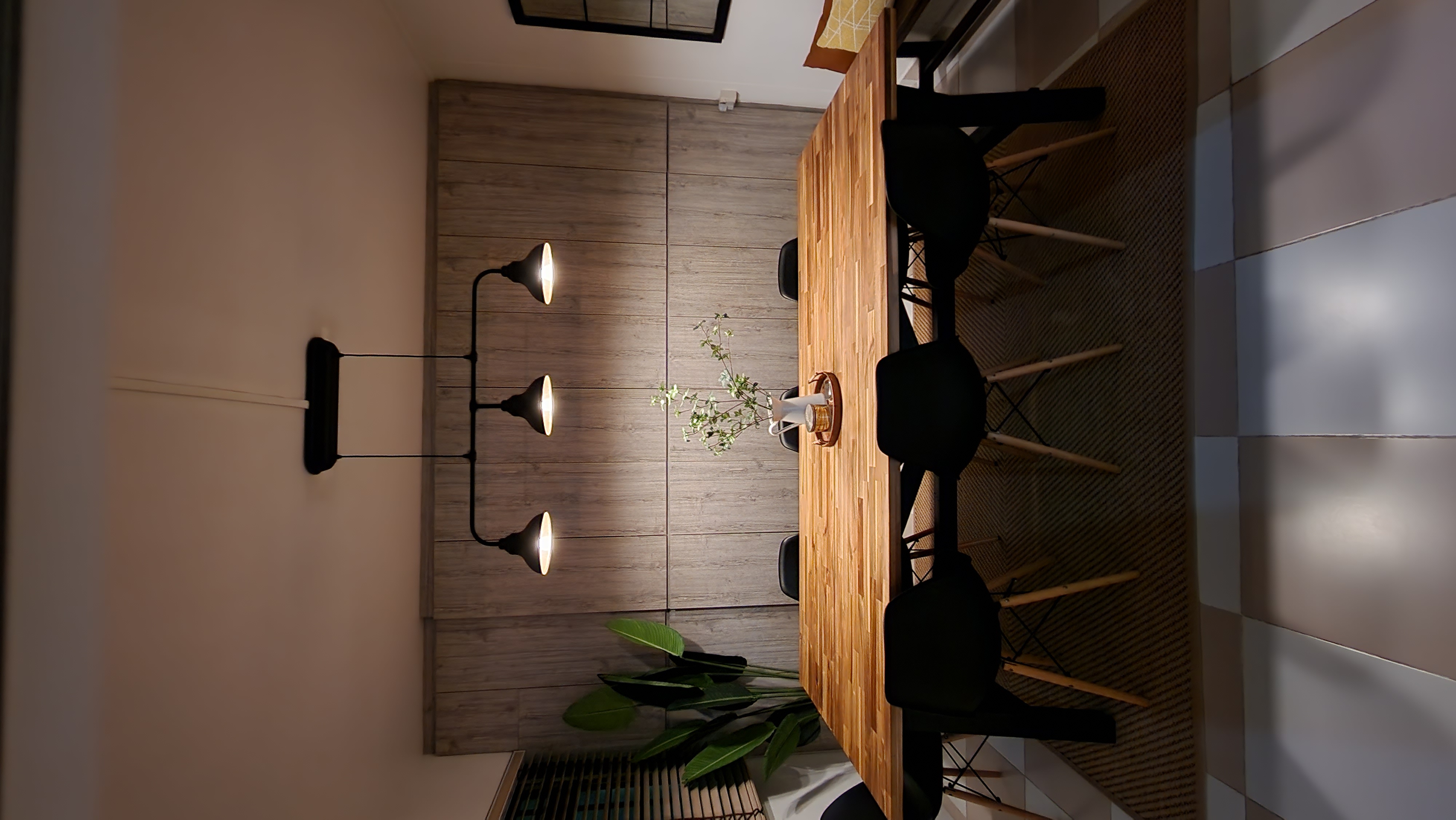 Multi-Functional Dining Room - Wooden dining table, black chairs, modern lighting, minimalist decor, natural light, textured