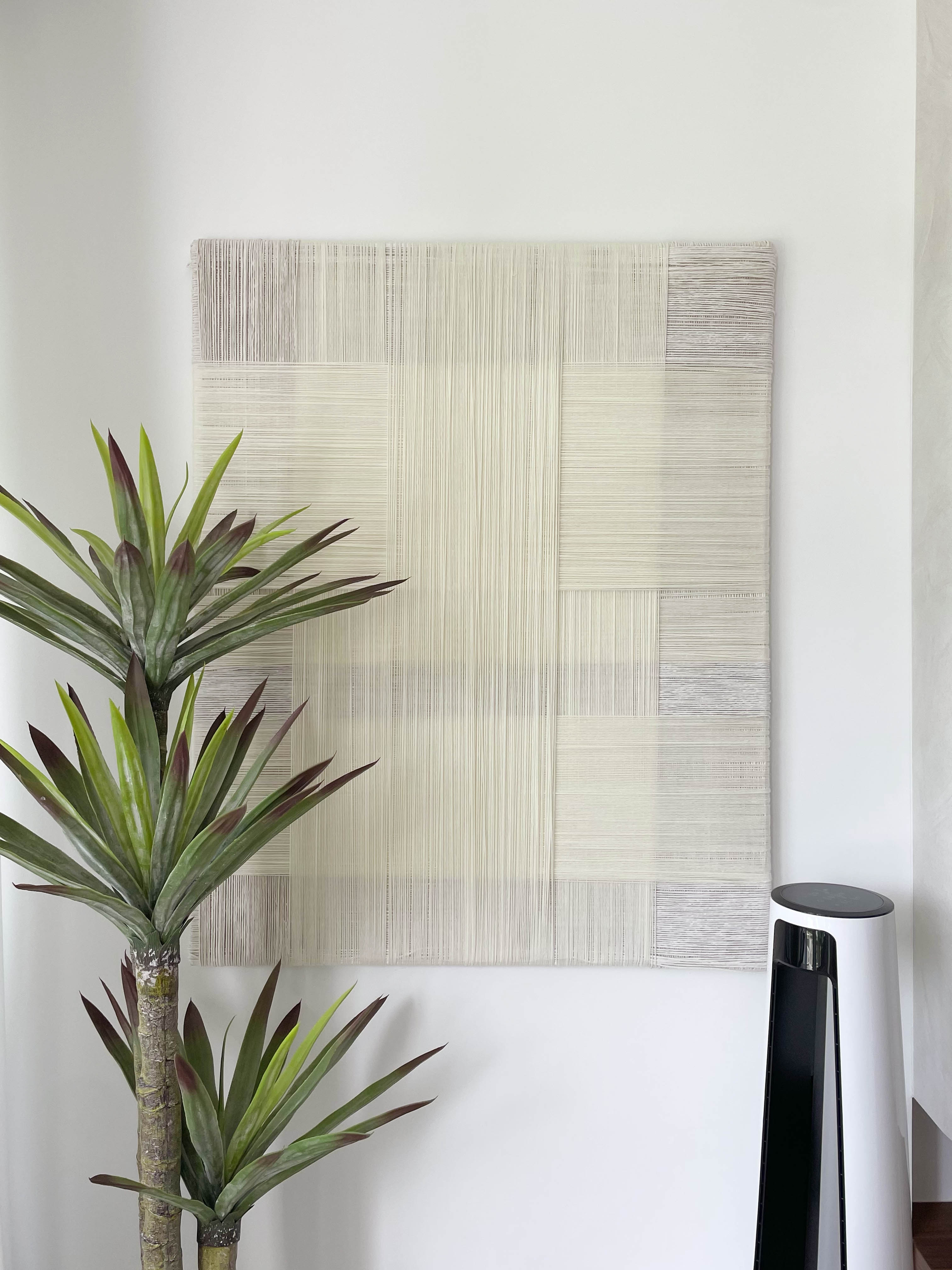 Creating A Cozy Living Room - Modern minimalist wall art, abstract woven design, vertical striped pattern, light beige color
