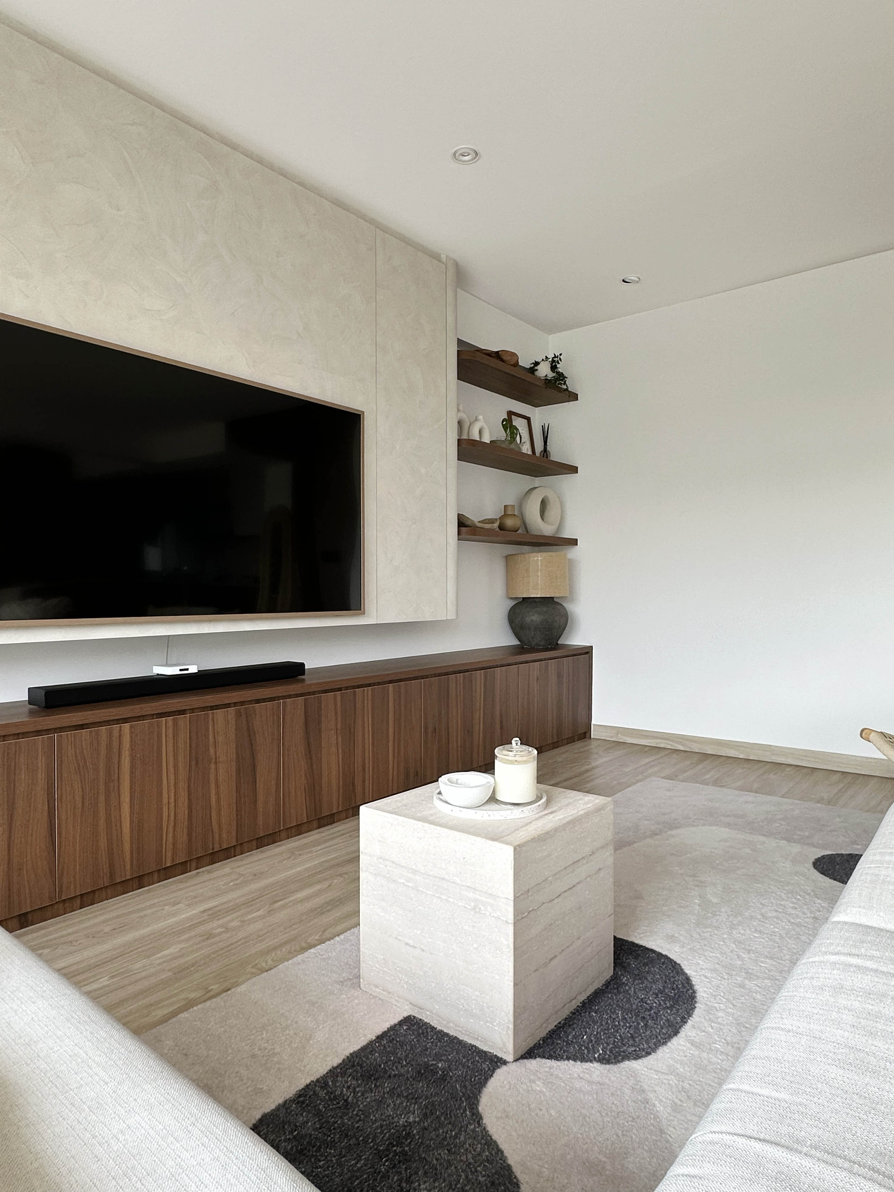 Creating A Cozy Living Room - Modern living room, minimalist design, large flat-screen TV, wooden entertainment center