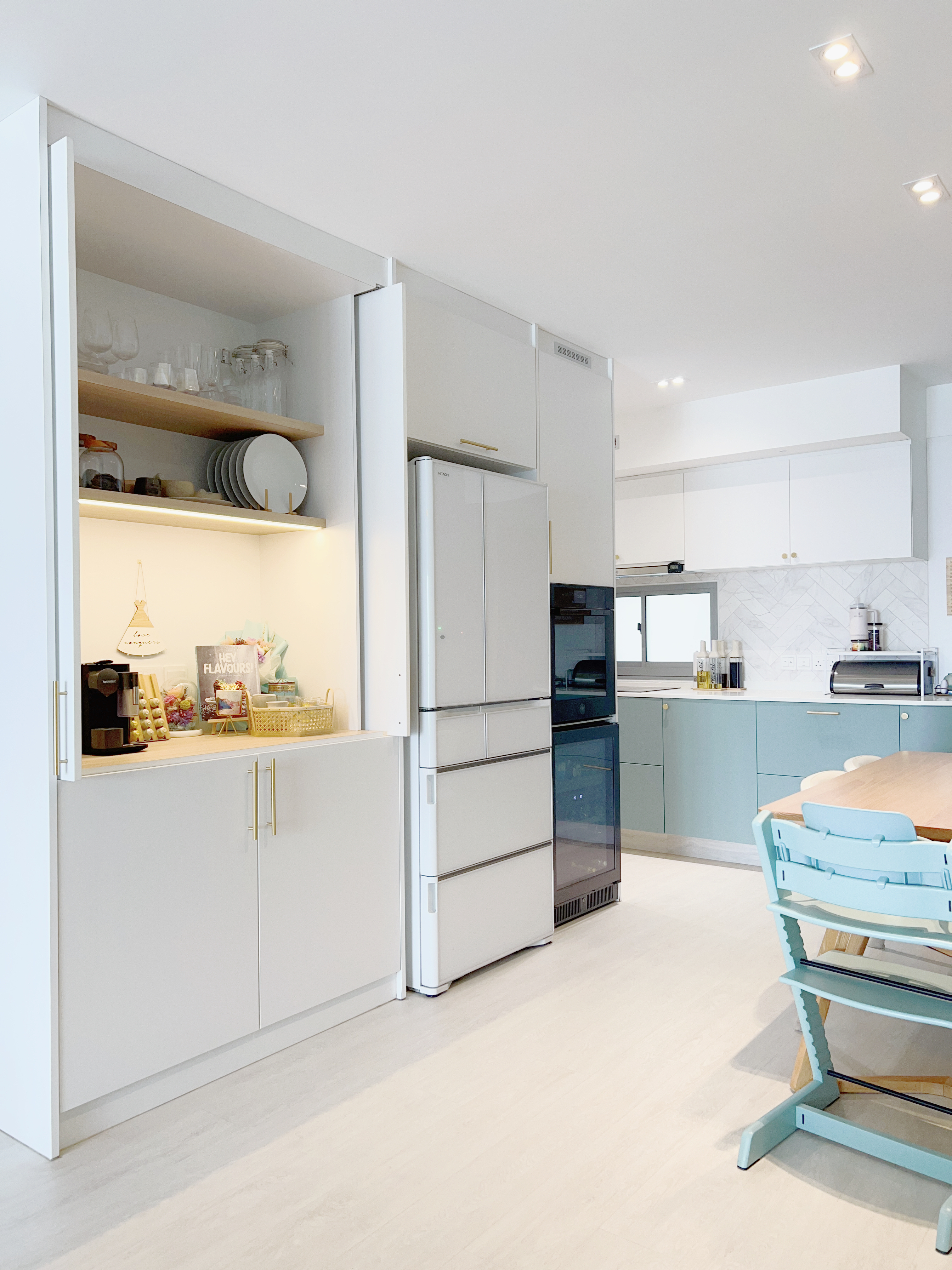 A Kids Friendly Kitchen + Dining Integrated Space  - White kitchen cabinets, modern design, open pantry, glassware, plates