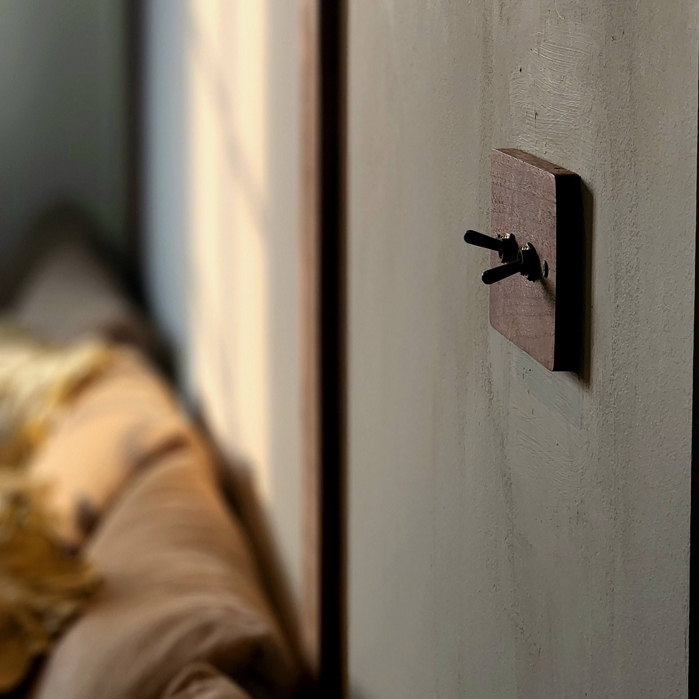 Gather here: Living and dining in the same space - Wall-mounted hook, wooden frame, black handle, beige bedspread, soft