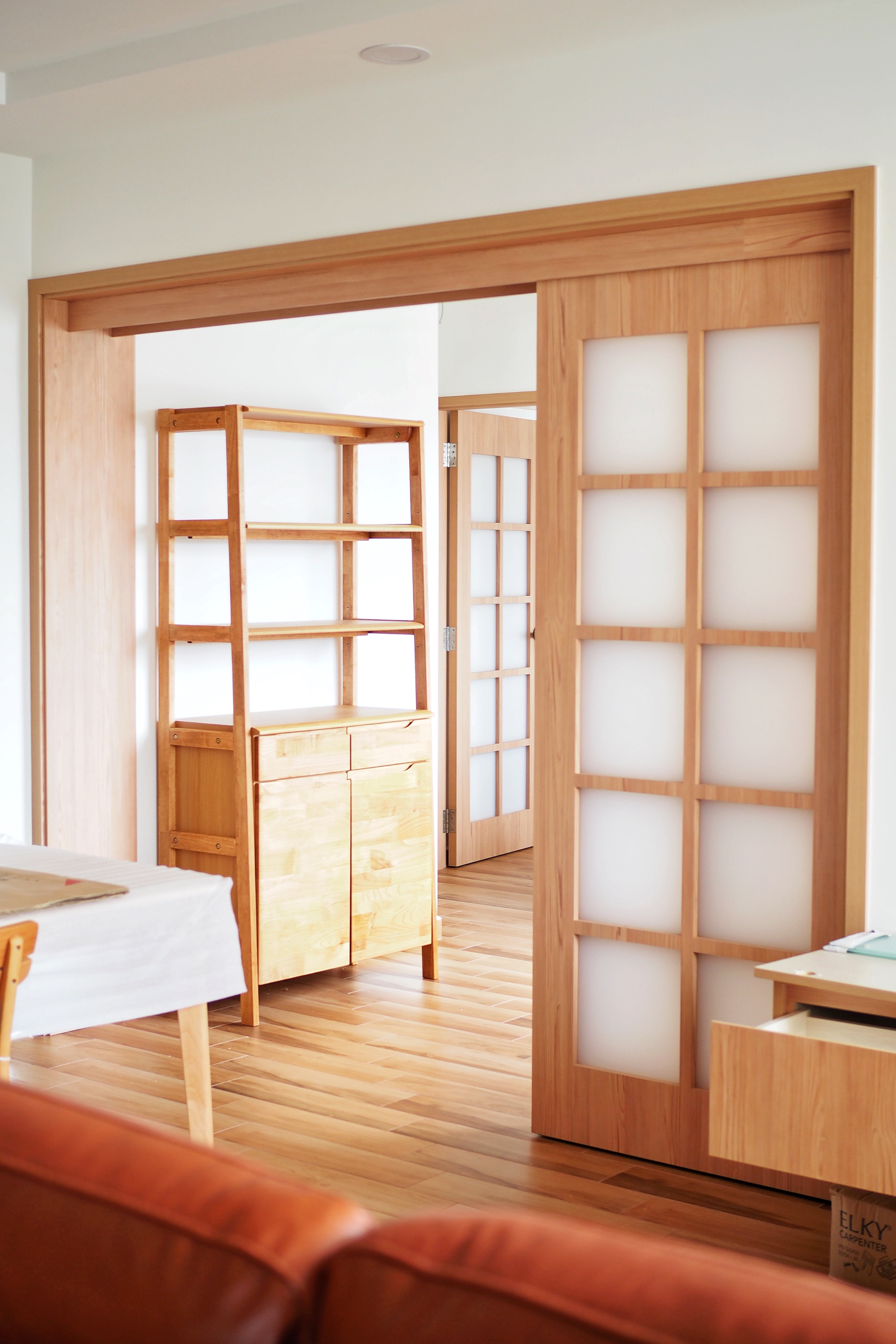 House Hunting: We found THE ONE 35 units later! - Wooden shelving unit, minimalist design, light wooden finish, open doorway